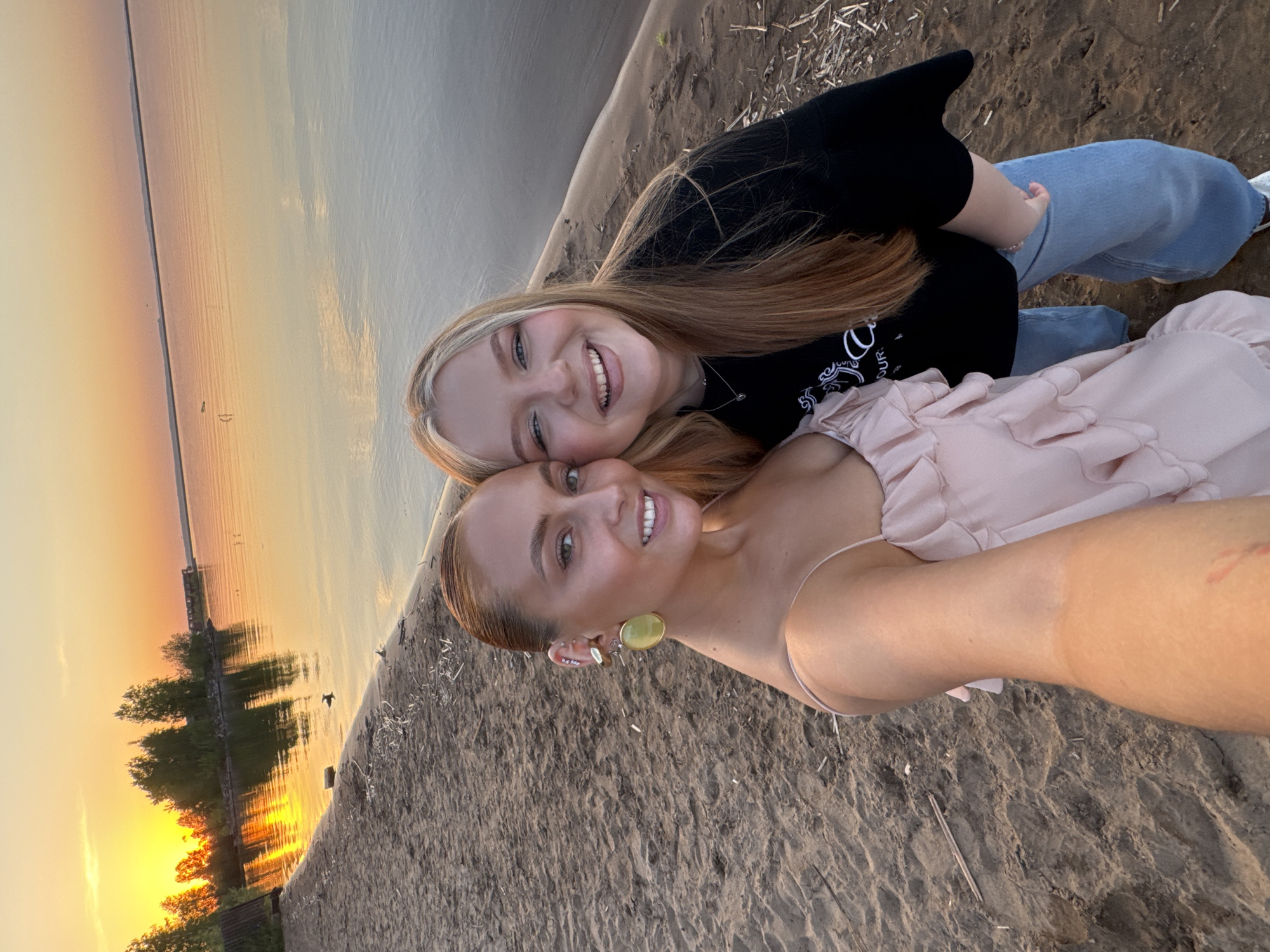 Two women take sunset selfies on Chaikovsky beach