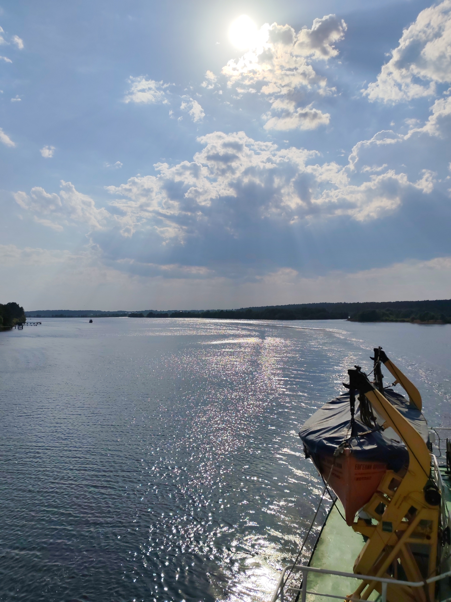 Boat travels Volga River near Kimry under sunny skies