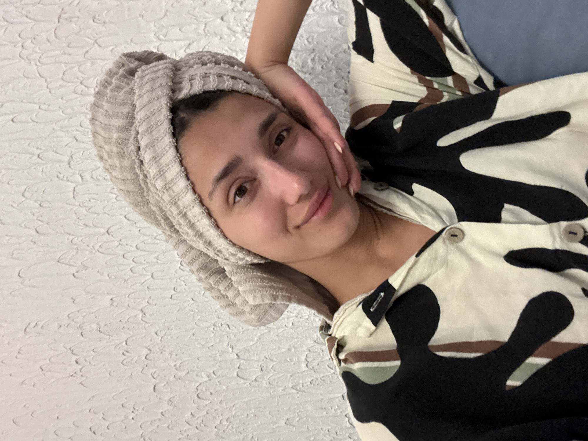 Woman in towel and patterned clothing observed in Sutomore