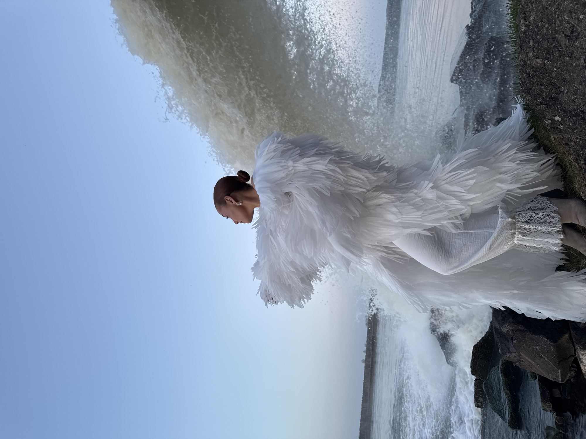 Woman in white dress photographed at Chernushka waterfall