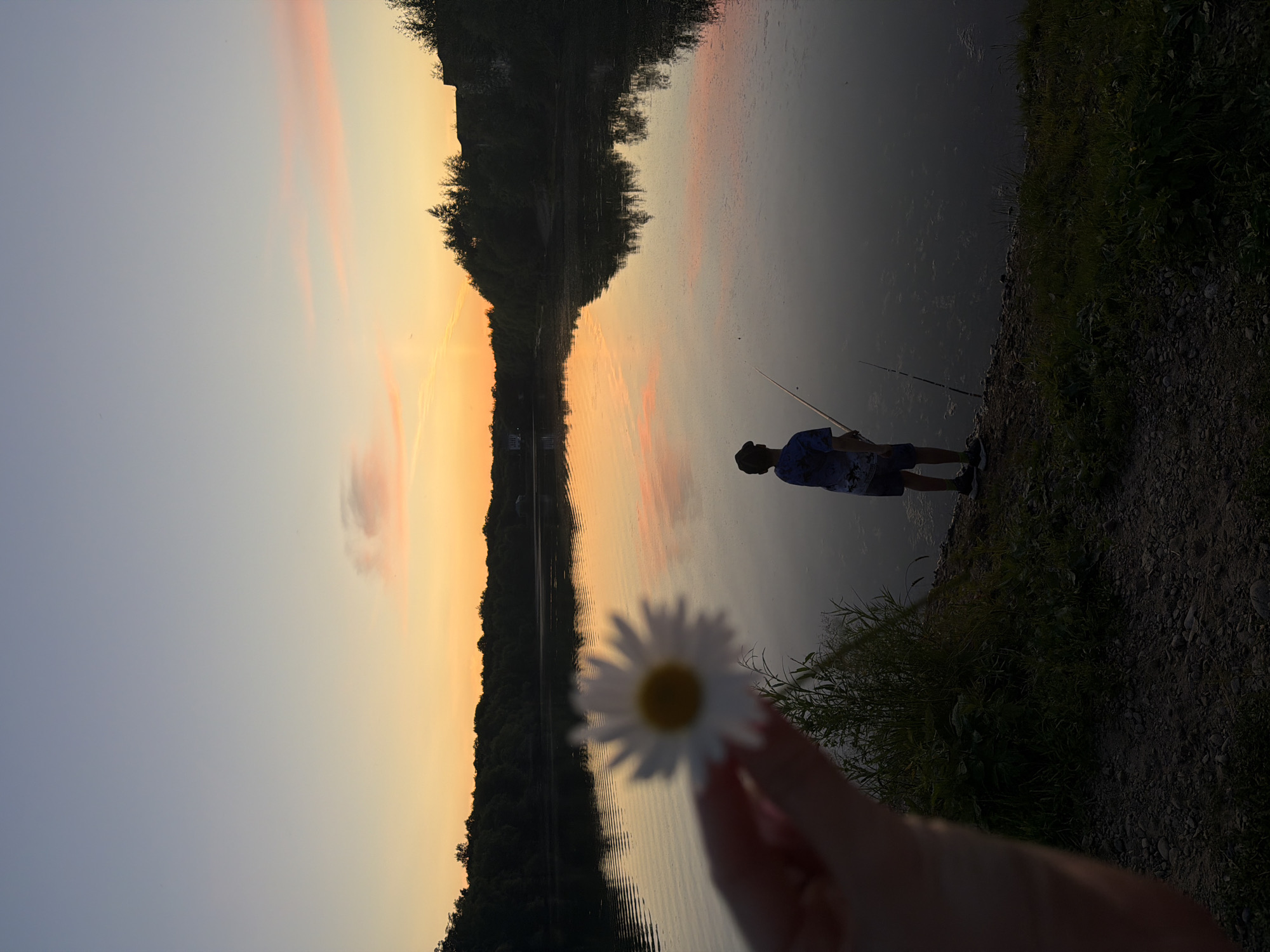 Fishing at dusk on a calm lake near Birobidzhan