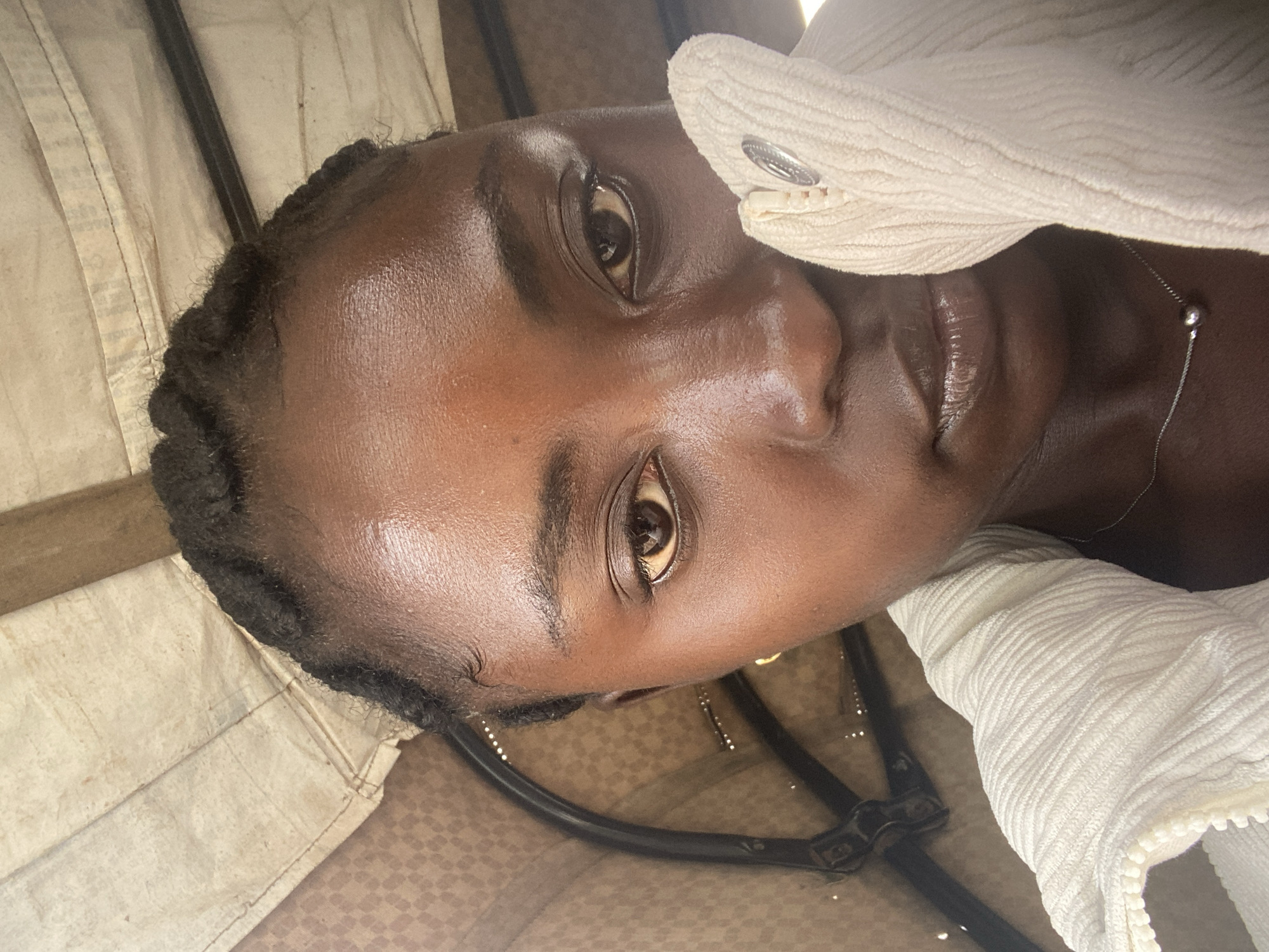 Portrait in Jos, Nigeria — braids, corduroy jacket, silver necklace.
