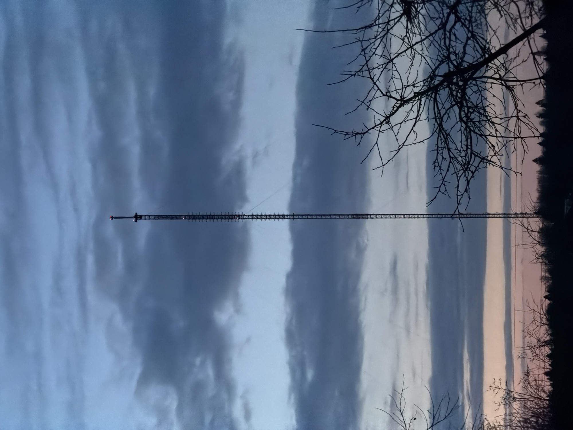Radio tower observed under cloudy skies in rural Russia