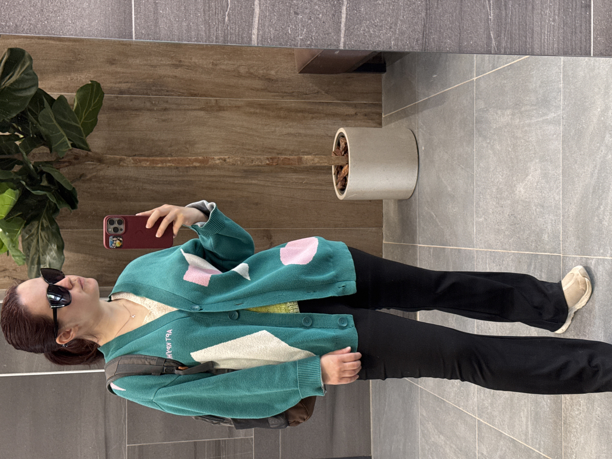Woman takes mirror selfie in Izhevsk building lobby