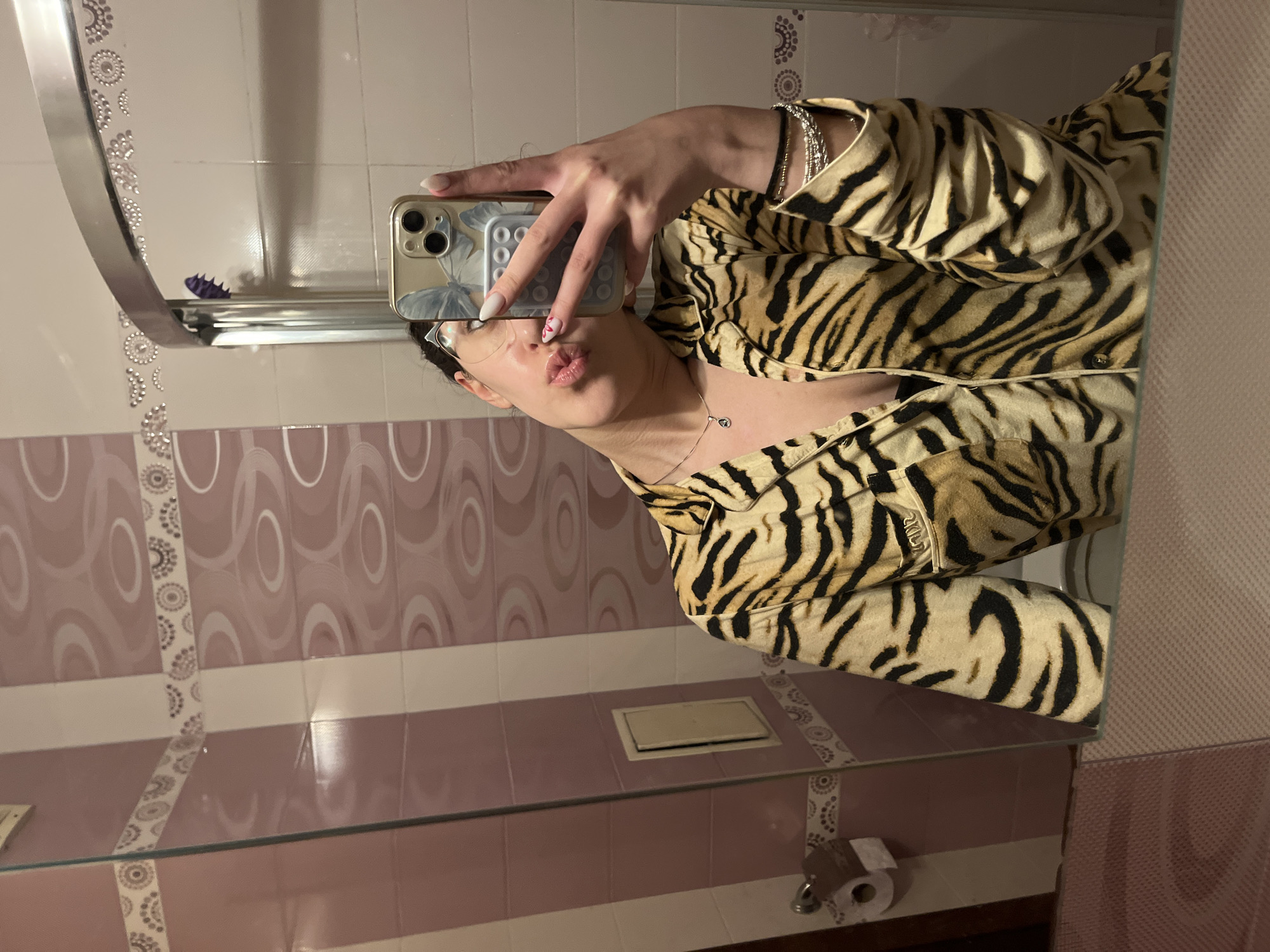 Person takes bathroom selfies in tiger-striped shirt in Sofia