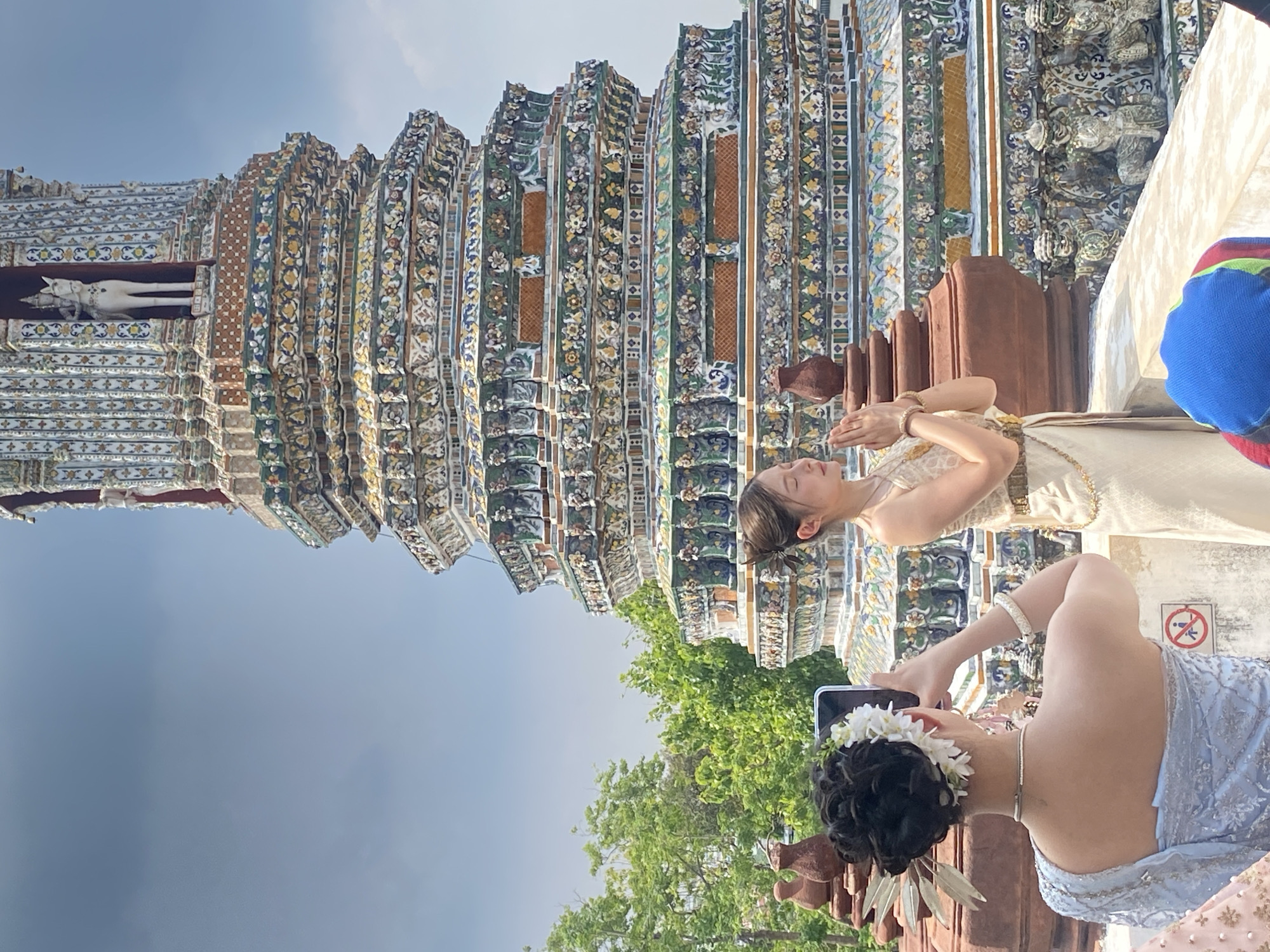Two women visit Wat Arun temple in Bangkok