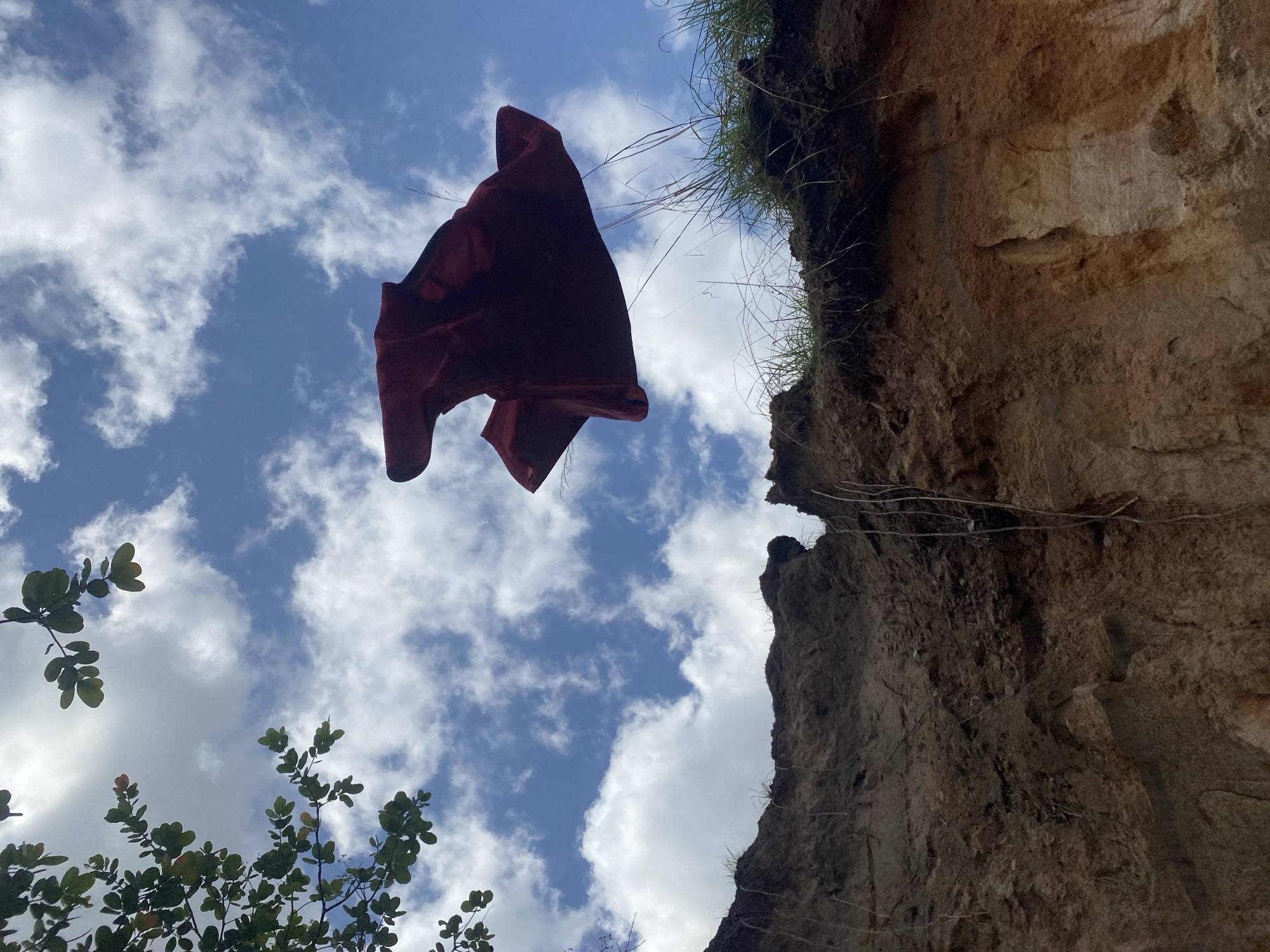 Red cloth caught suspended mid-air near cliff in Amaseri
