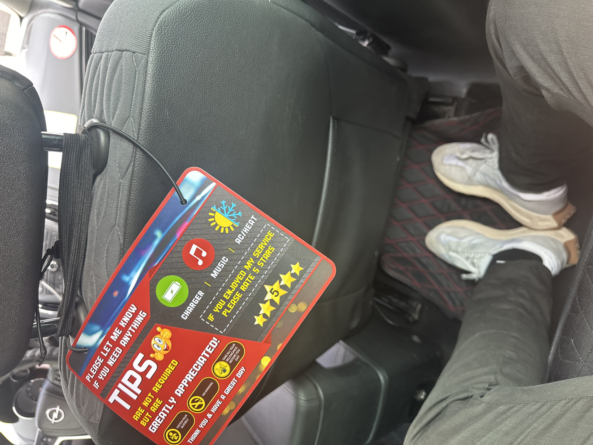 Driver displays customer service sign in Sofia vehicle