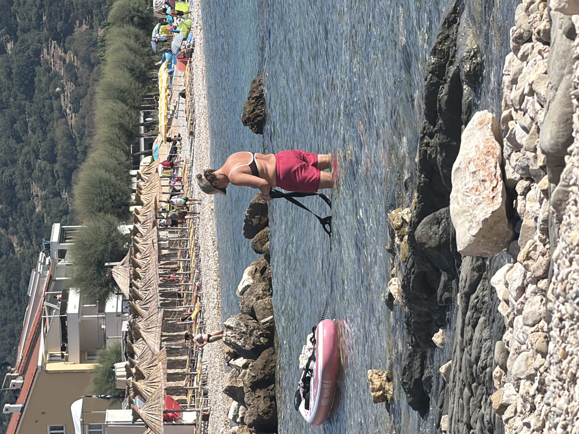 Summer morning at Baška's rocky beach, dogs and pedal boats included
