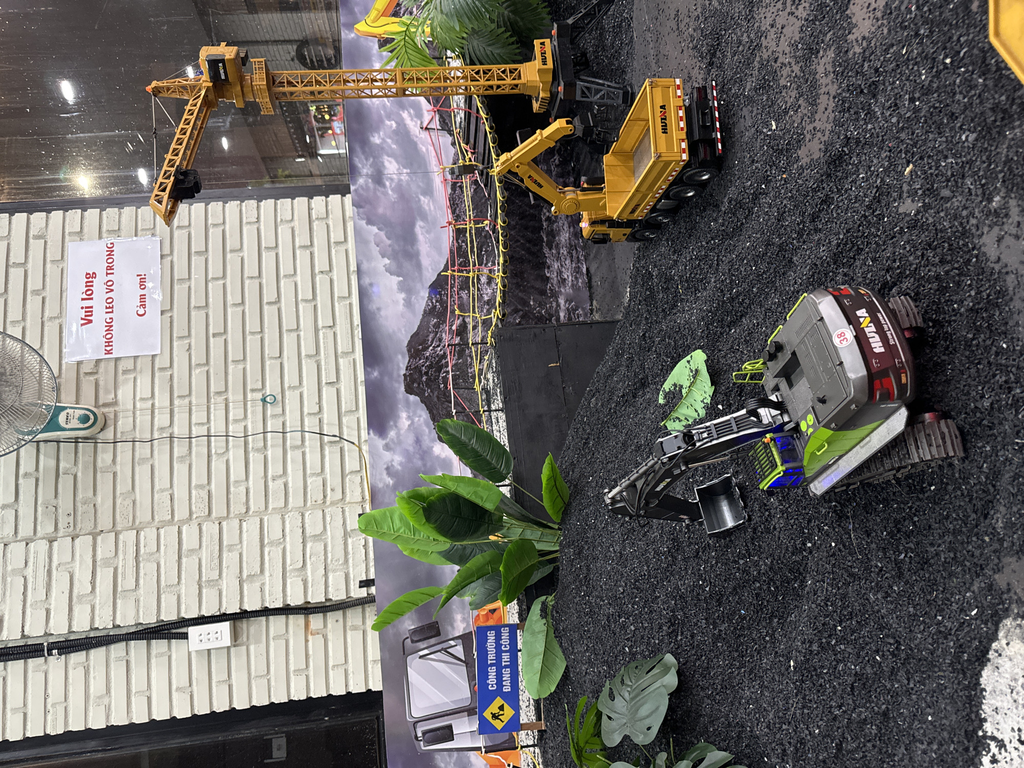 Family visits RC construction toy center during Vietnam rainstorm