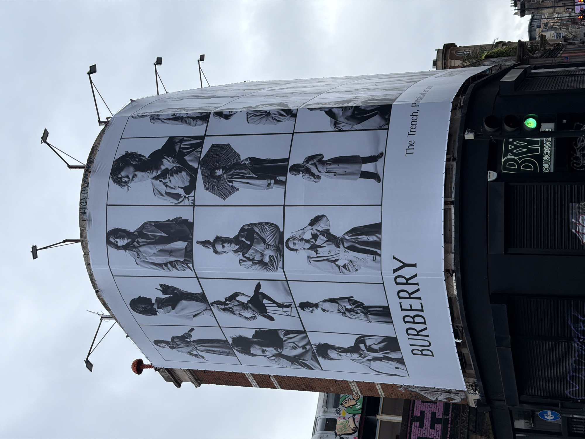 Pedestrian passes Burberry billboard during morning walk in London