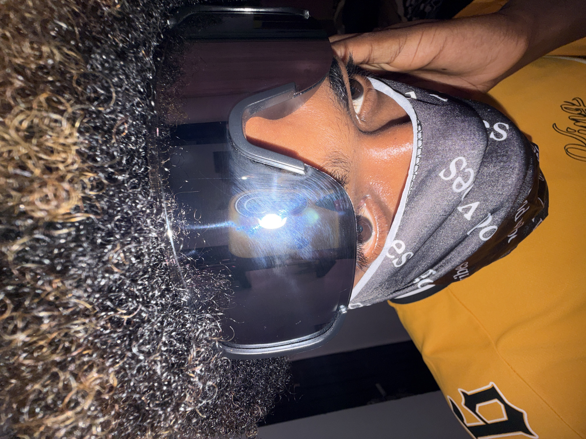 Person in goggles and patterned head covering photographed