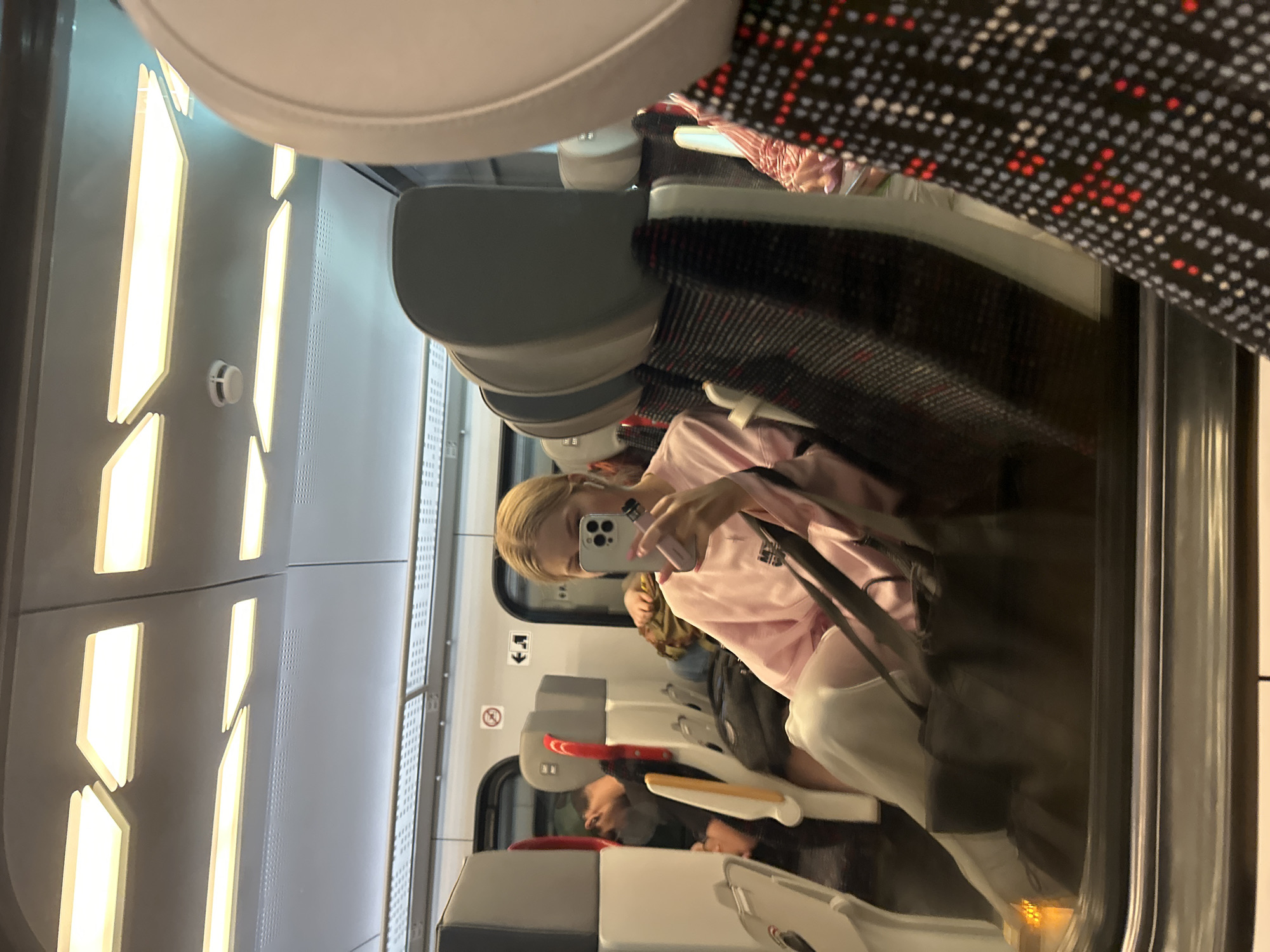 Selfie in a train window reflection, Gdynia evening