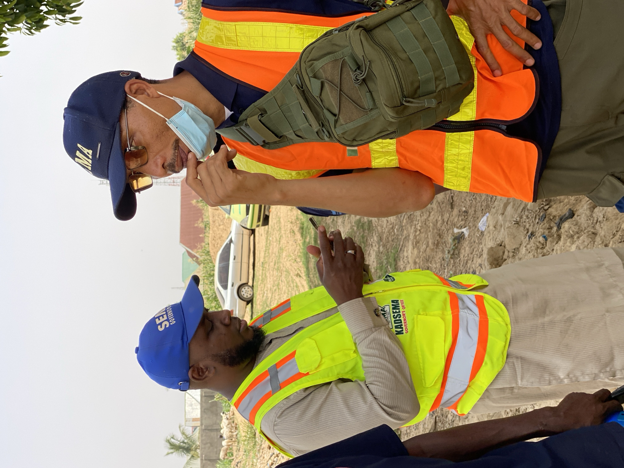 Officials gather in dirt lot in Rigachikun, Nigeria