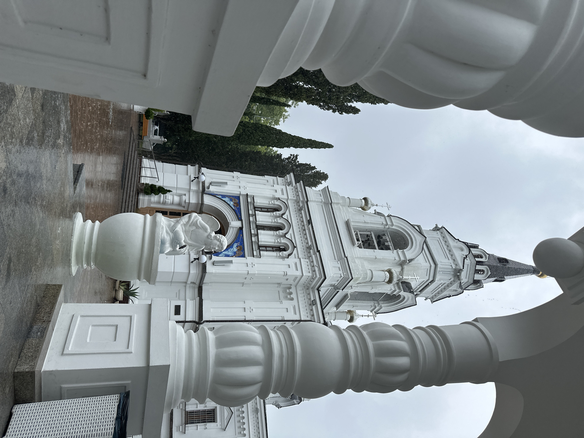 Rainy day at a white Orthodox church complex in Sochi