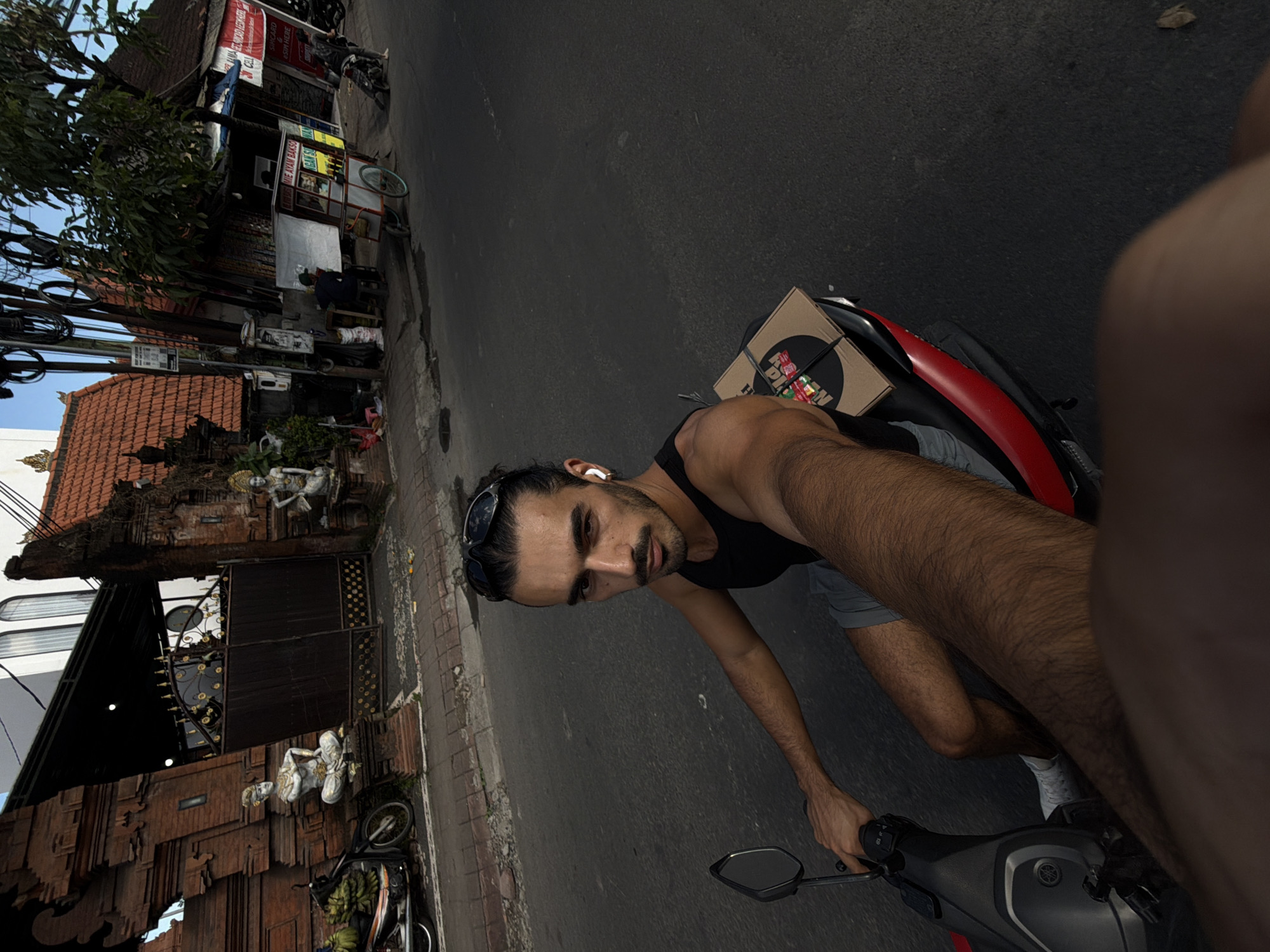 Scooter rider captures selfies during morning ride in North Kuta