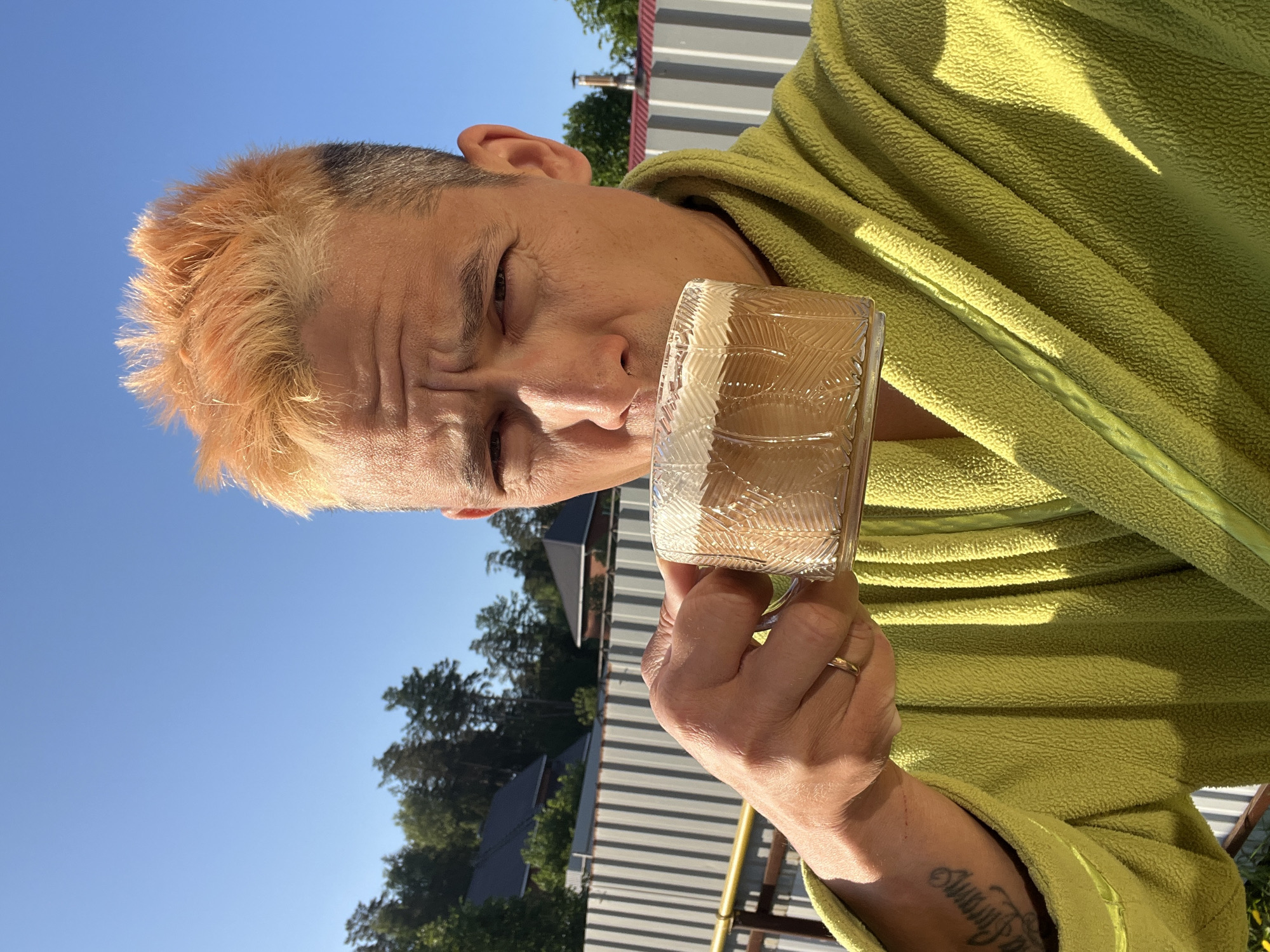Man enjoys morning beverage outdoors in Chaikovsky, Russia