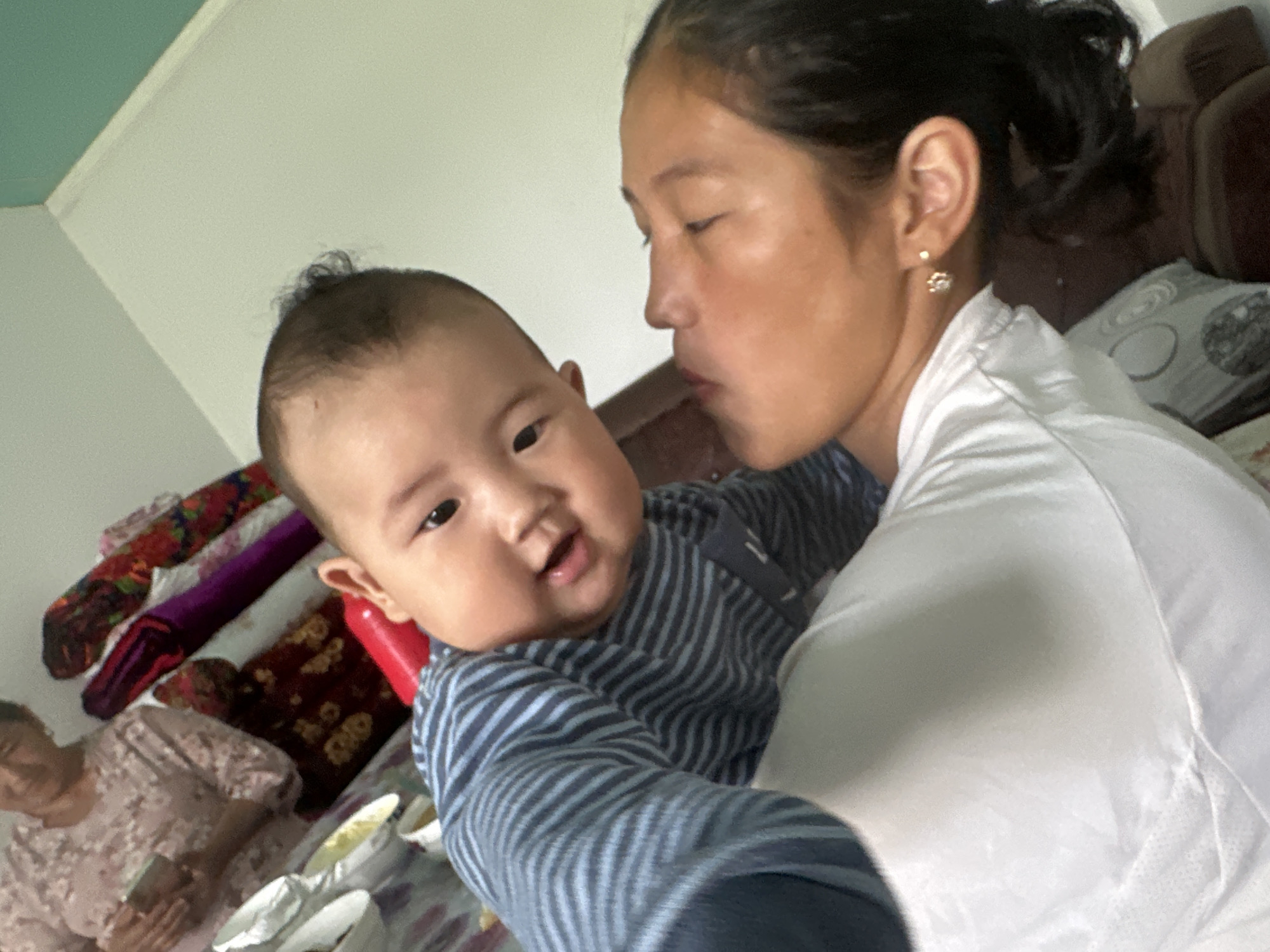 Home gathering in Kyrgyzstan with a baby, gifts, and car work