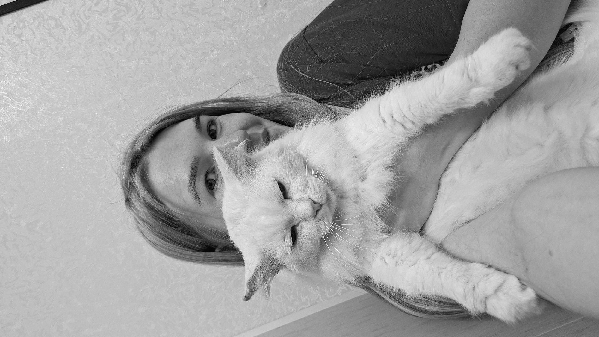Woman photographs herself with white cat in Russian village