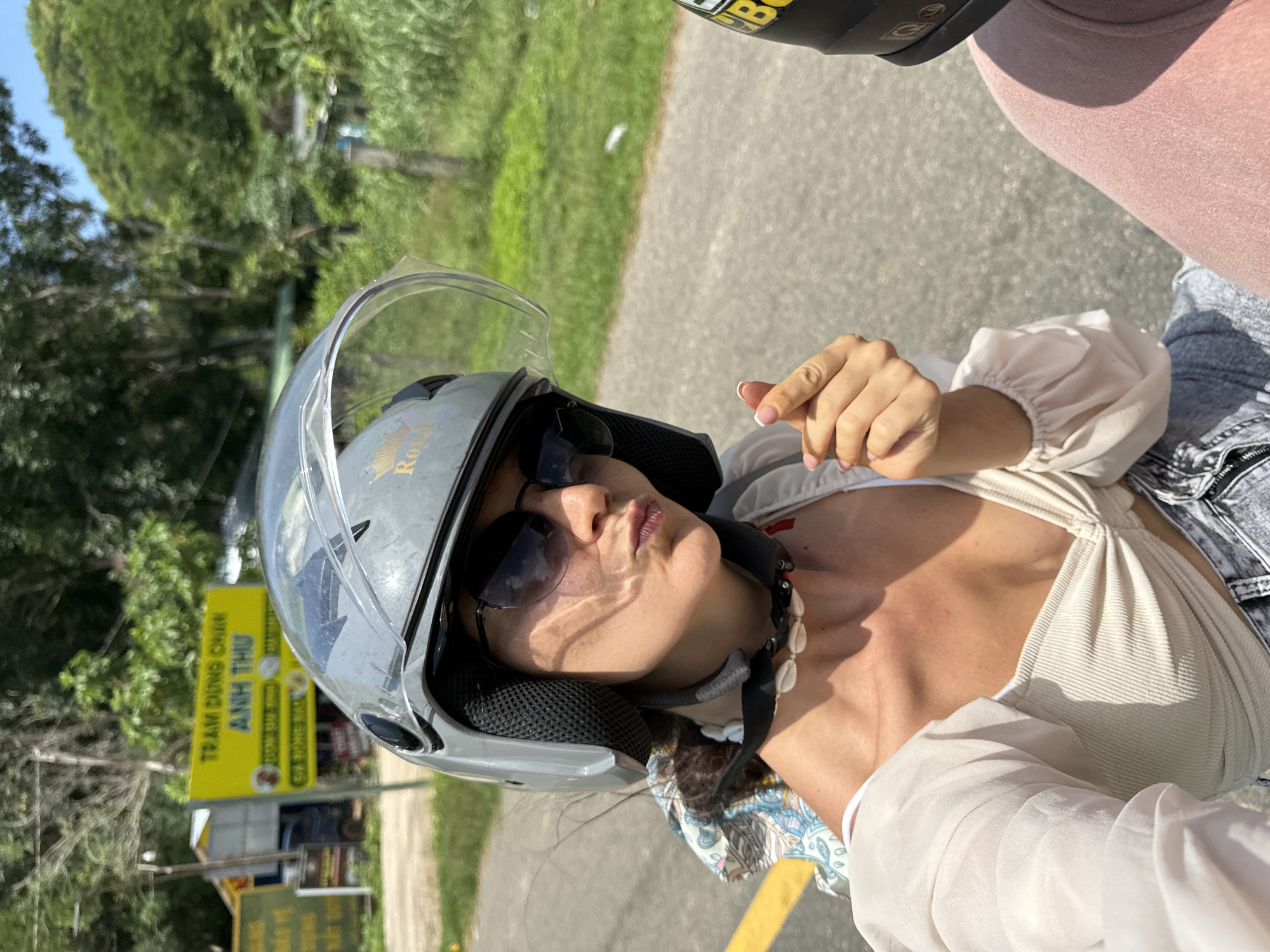 Woman on motorcycle encounters cattle herd on rural Vietnam road