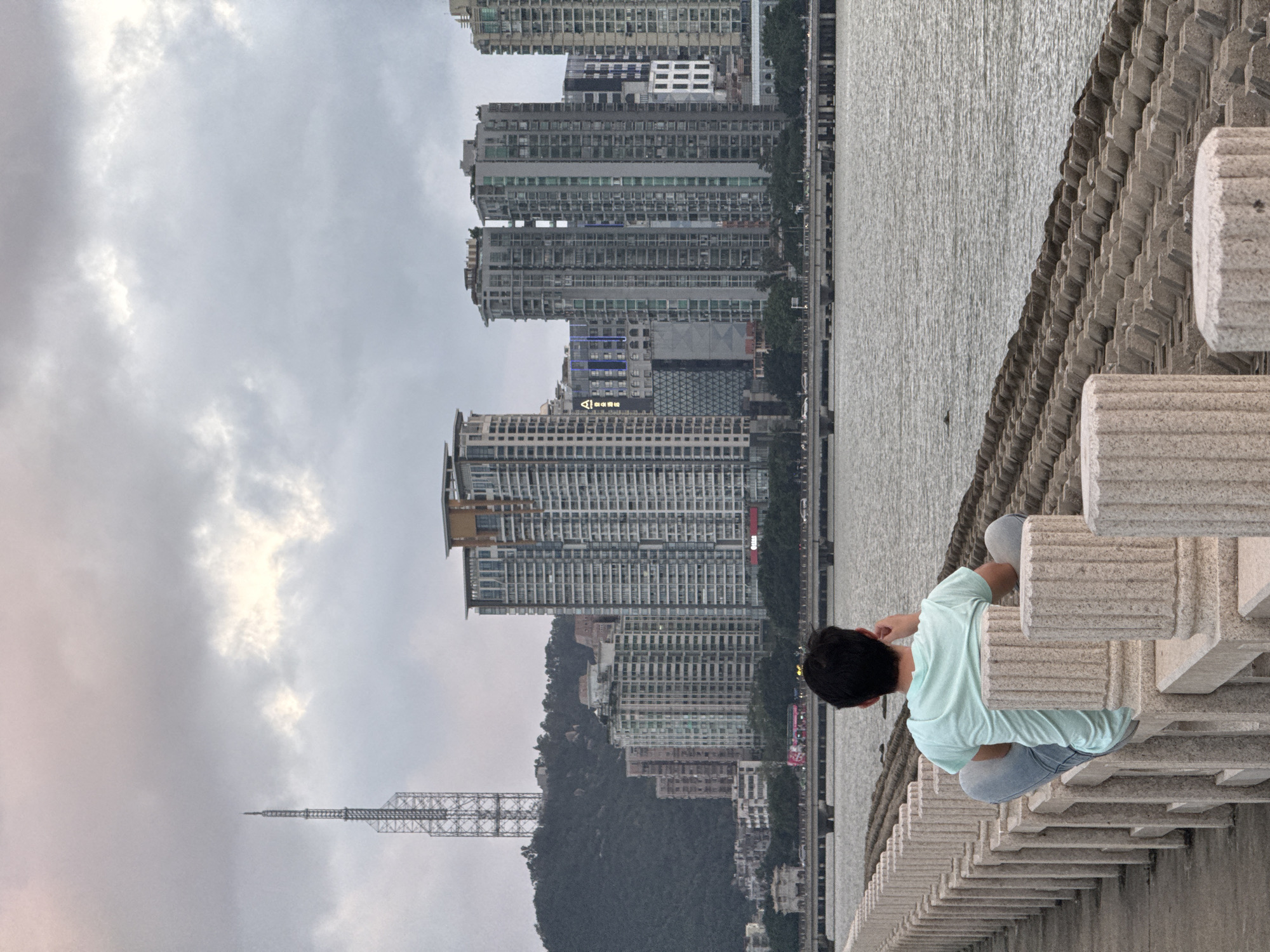 Morning scenes along Xiangzhou waterfront show people with phones