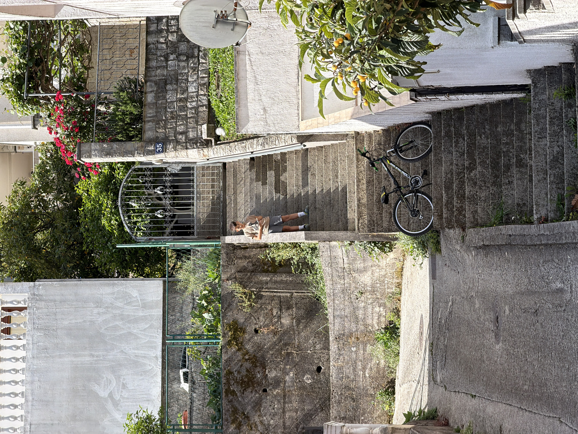 Person lying on concrete stairs in Budva, Montenegro