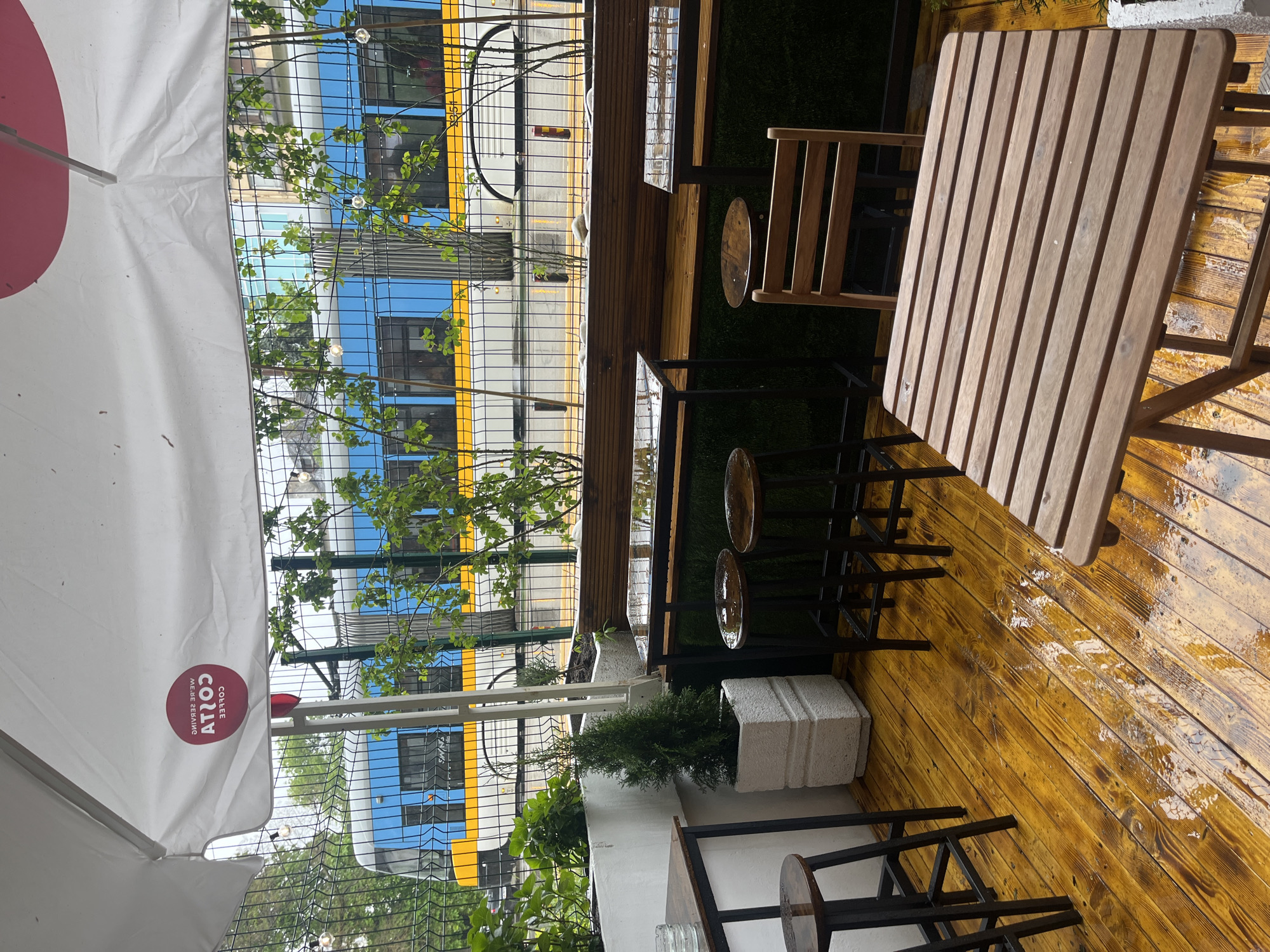 Wet wooden terrace observed at Sofia cafe Thursday morning