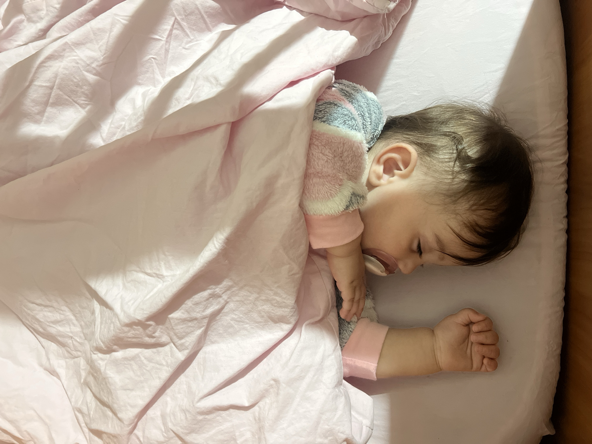 Baby sleeps peacefully in crib in Elena, Bulgaria