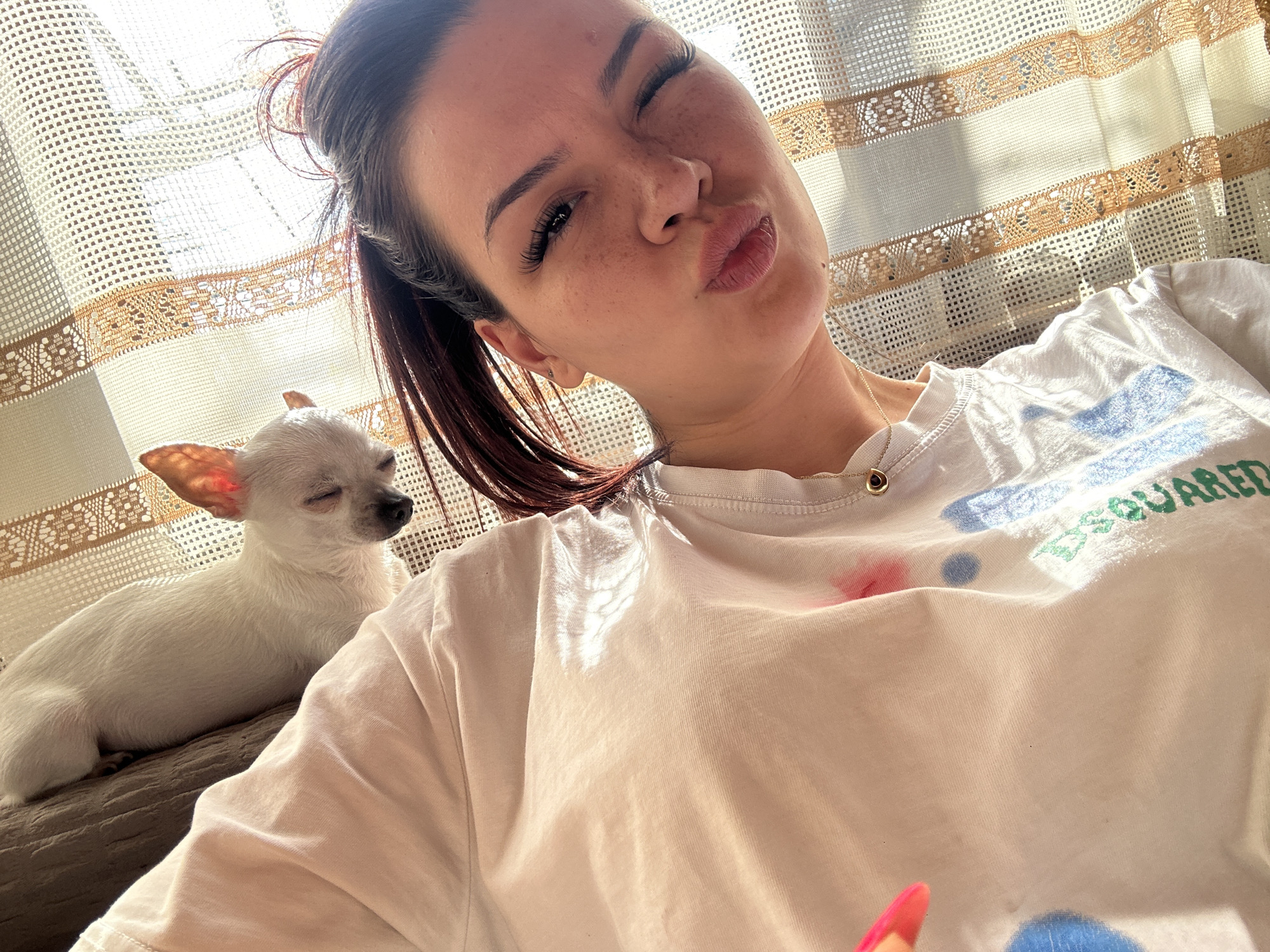 Woman poses with white chihuahua in Bulgarian home