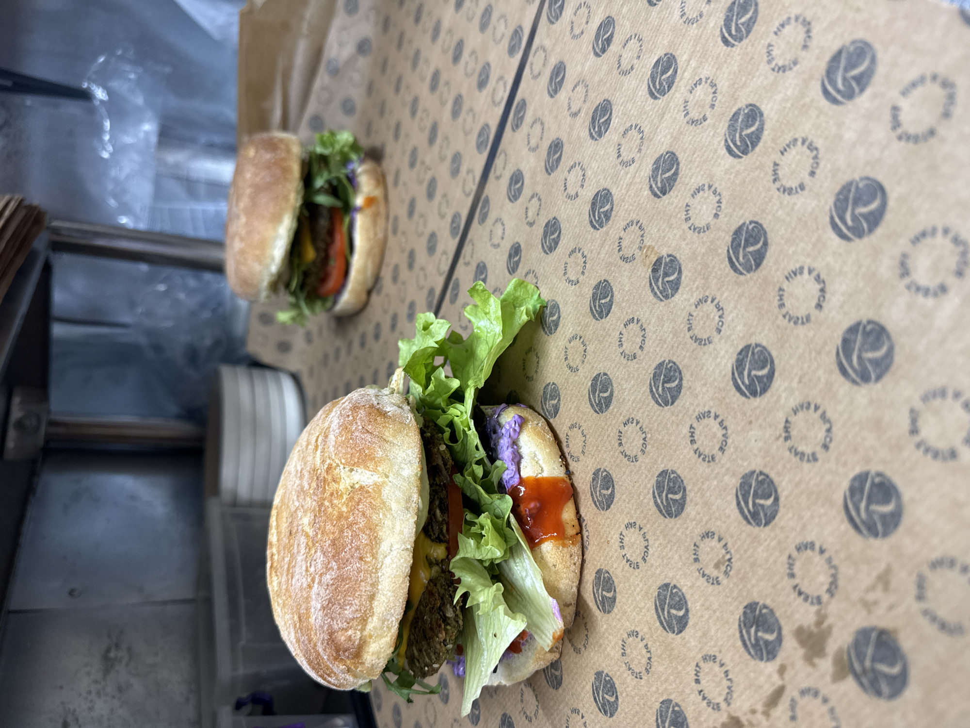 Two prepared sandwiches displayed on cardboard surface