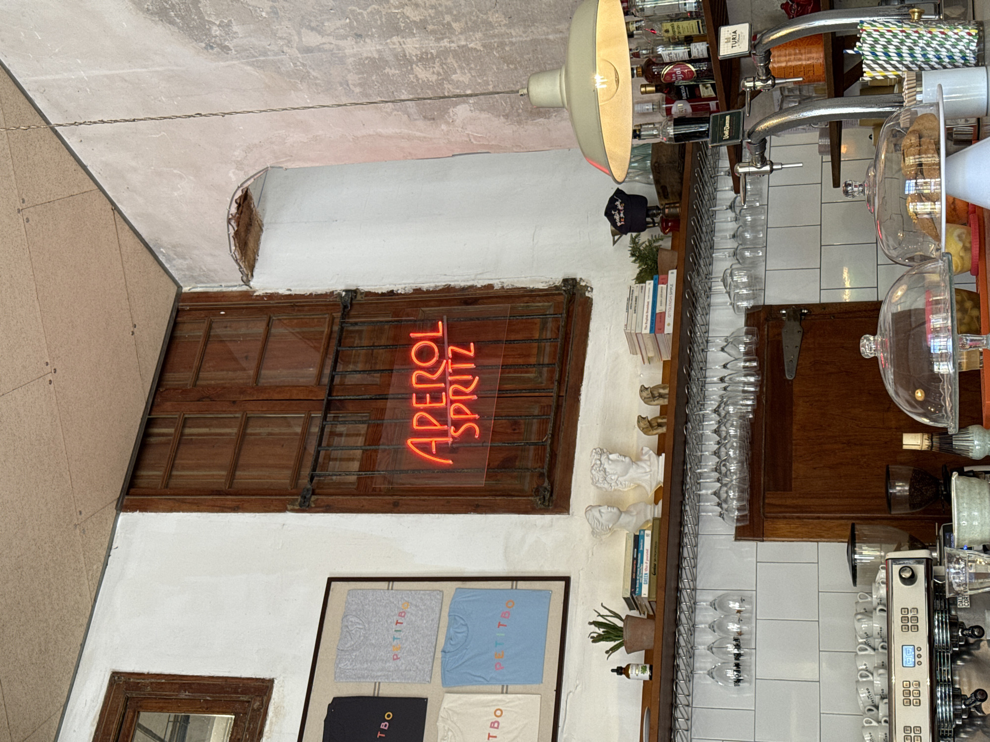 Barcelona cafe interior captured with Aperol Spritz neon signage