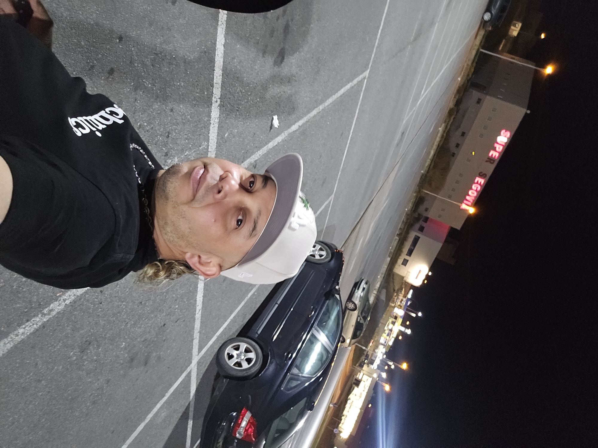 Nighttime selfies taken outside Super Segovia building parking lot