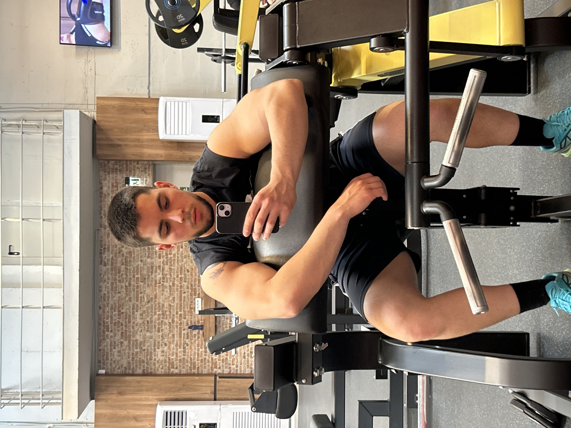 Man exercises at Sofia gym, uses leg press machine