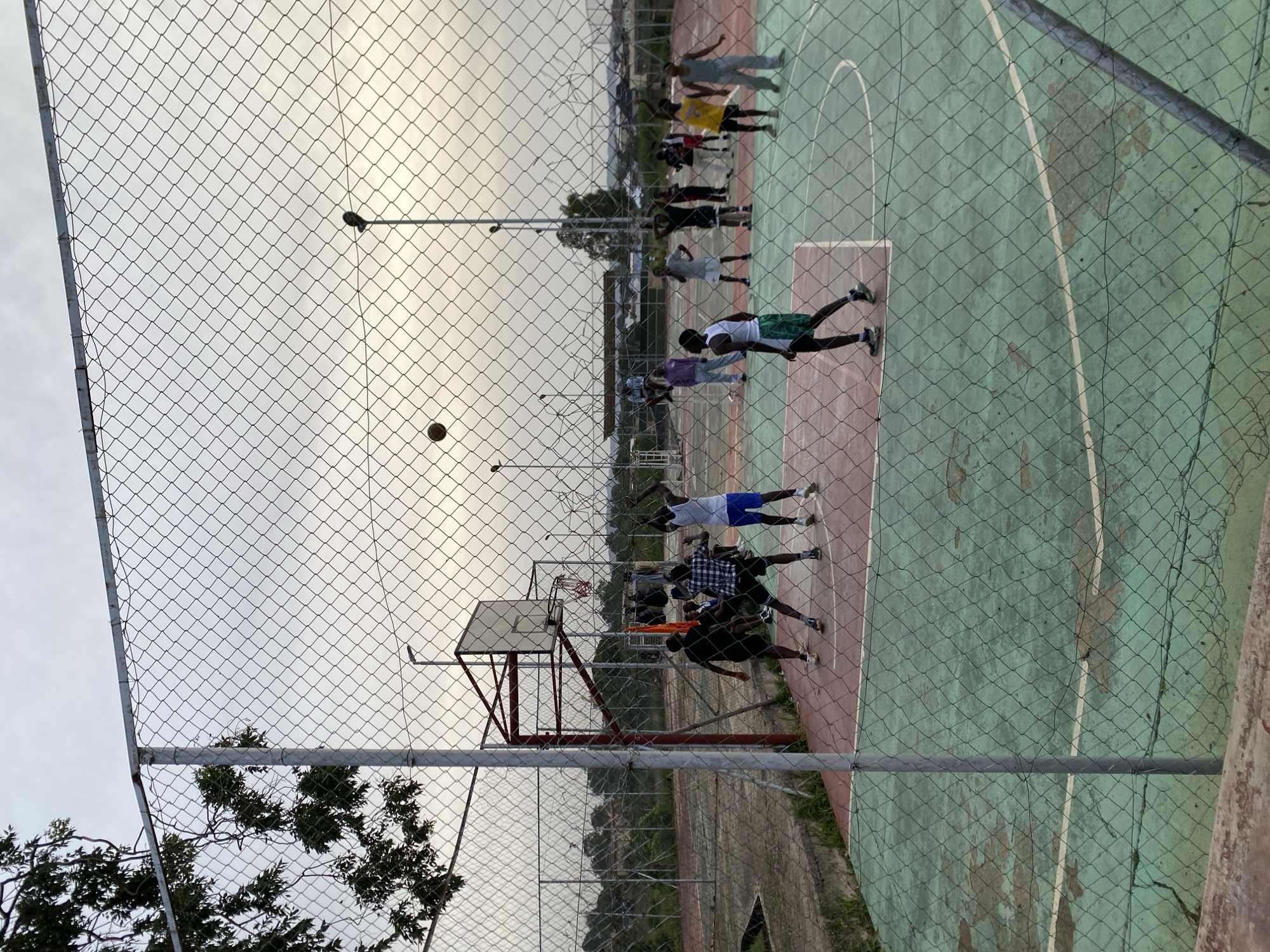 Basketball pickup game at an outdoor court in Jos, Nigeria