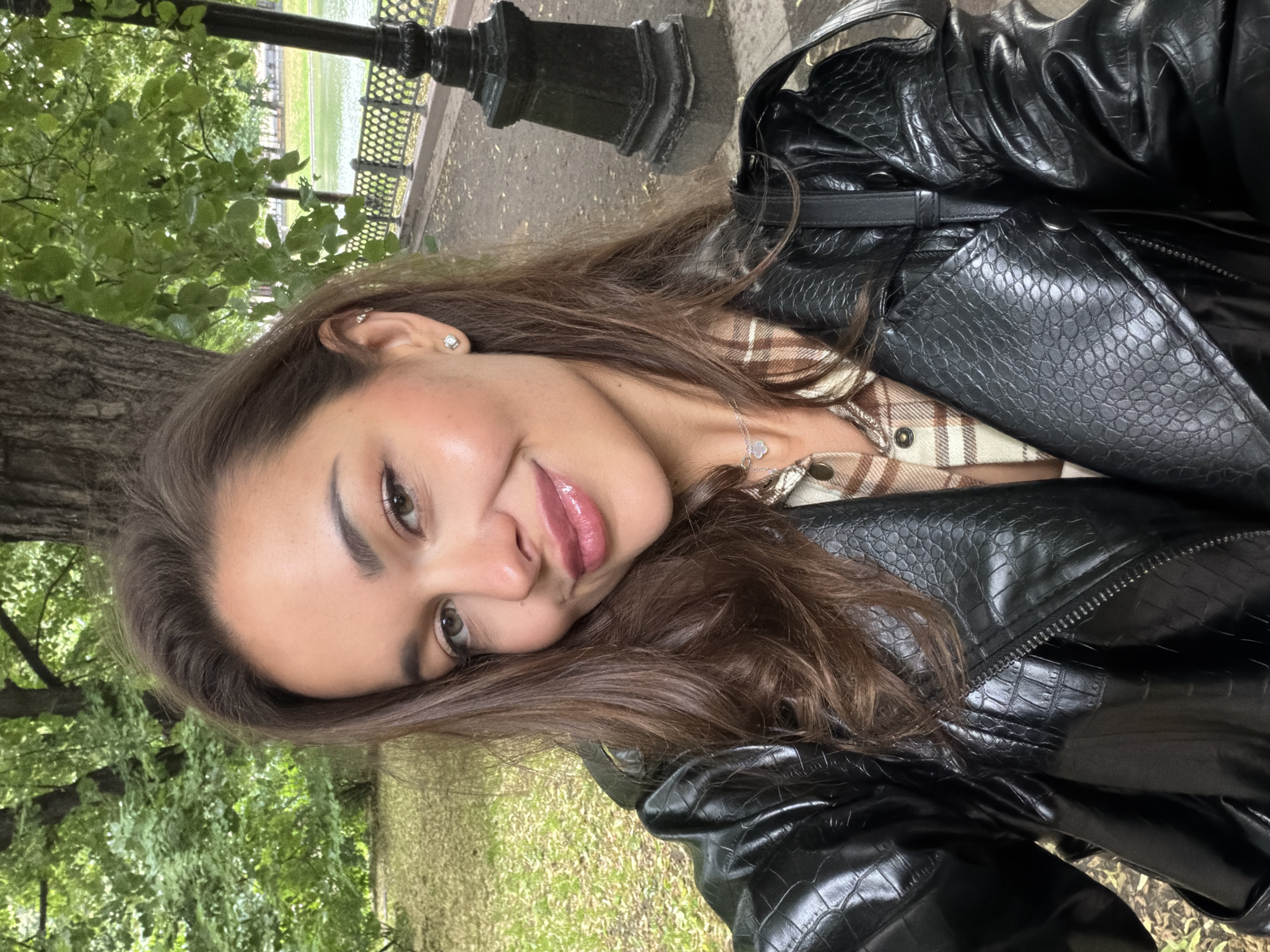 Casual park portraits in Moscow, leather jacket and green trees.
