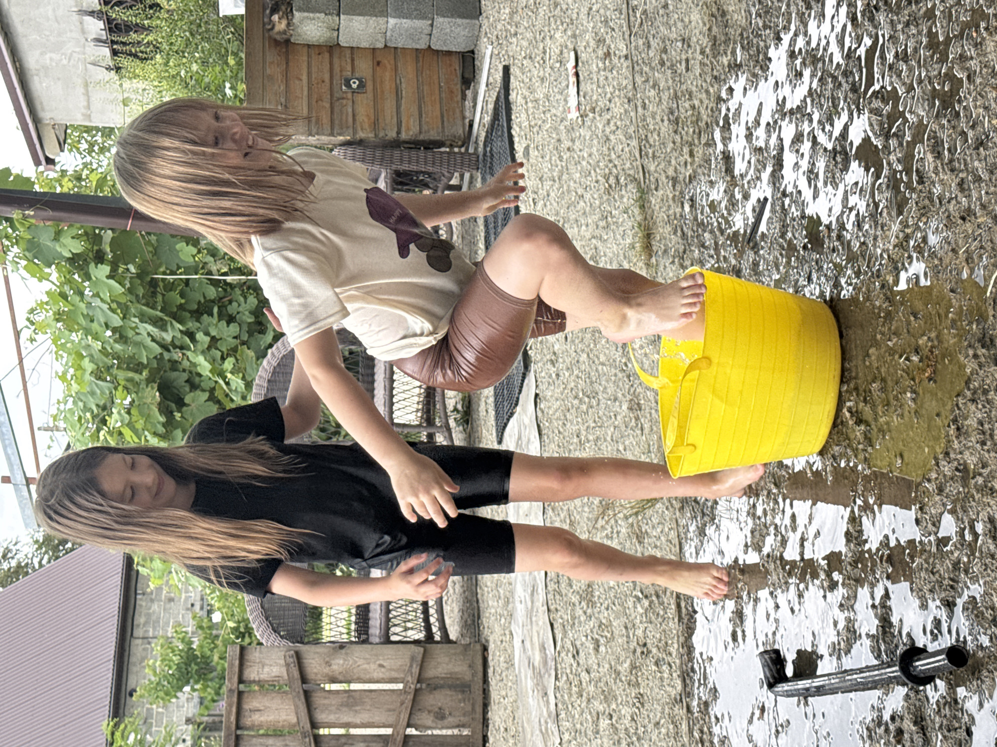 Summer water play around a yellow bucket in Zassovskaya
