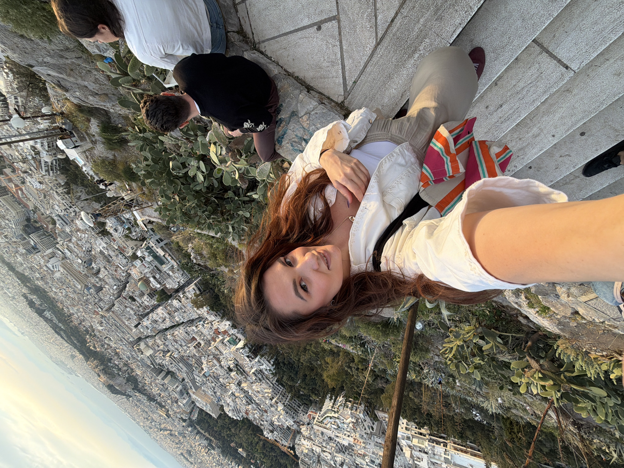 Woman takes sunset selfies at Athens scenic overlook