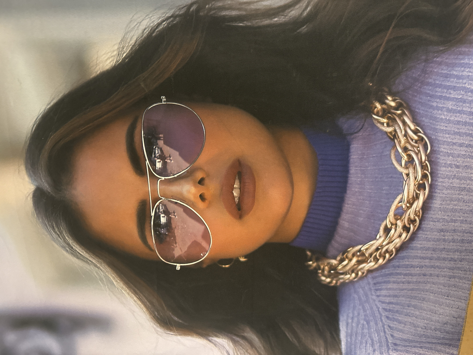 Woman in aviators and gold chain observed twice