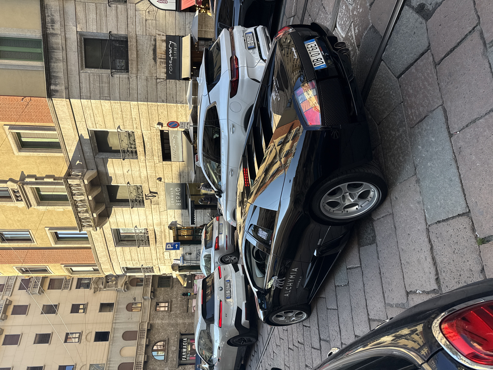 Branded Lamborghini cruises through sunny Milan street scene