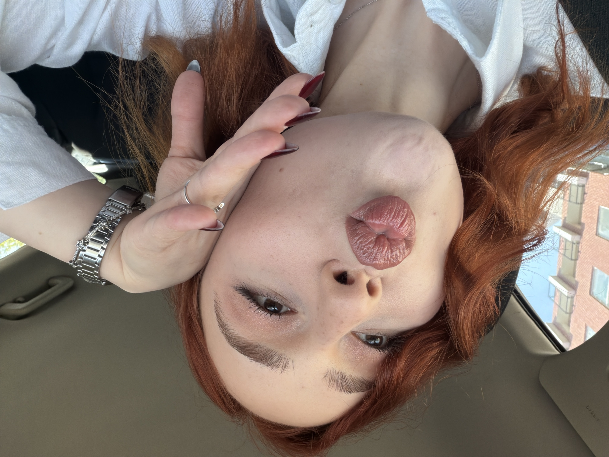 Woman photographed in multiple poses near vehicle in Tbilisi
