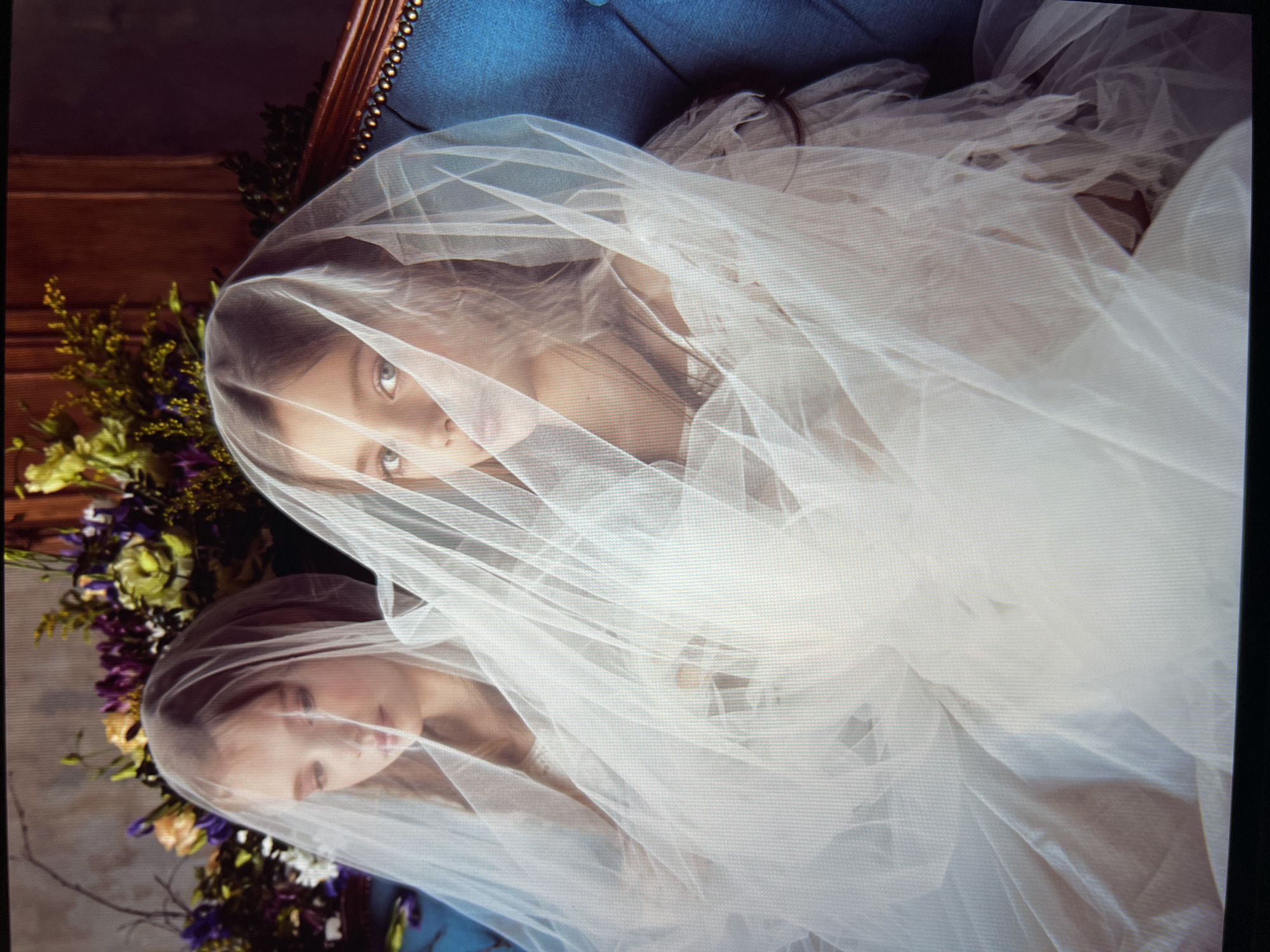 Formal studio portrait session, white dresses on blue velvet sofa