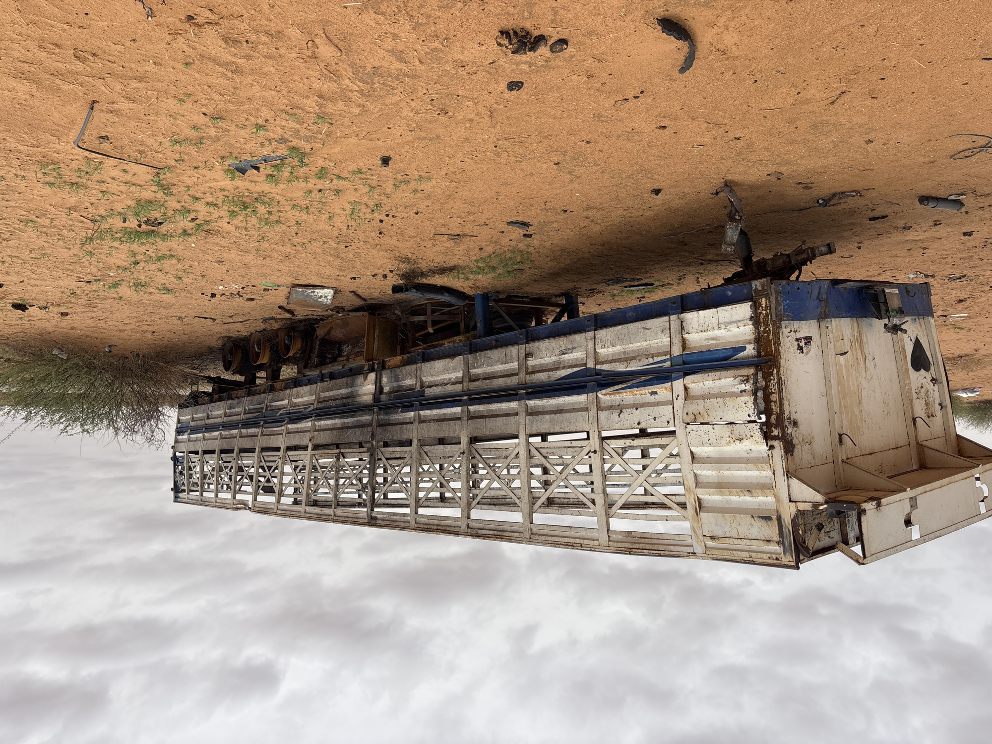 Abandoned livestock trailer rusting in Sudan's desert terrain