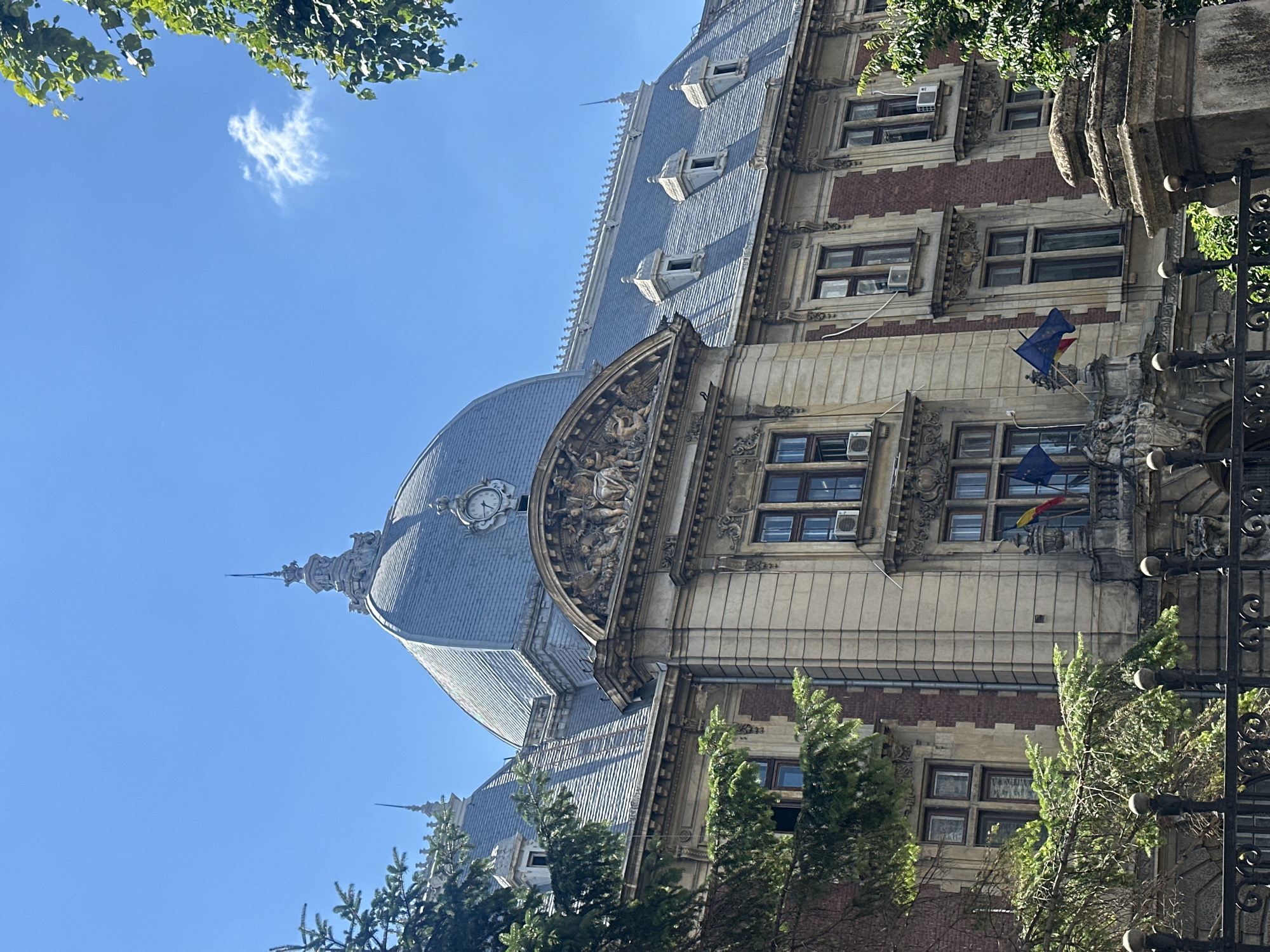 Domed classical building with ornate details on a clear day