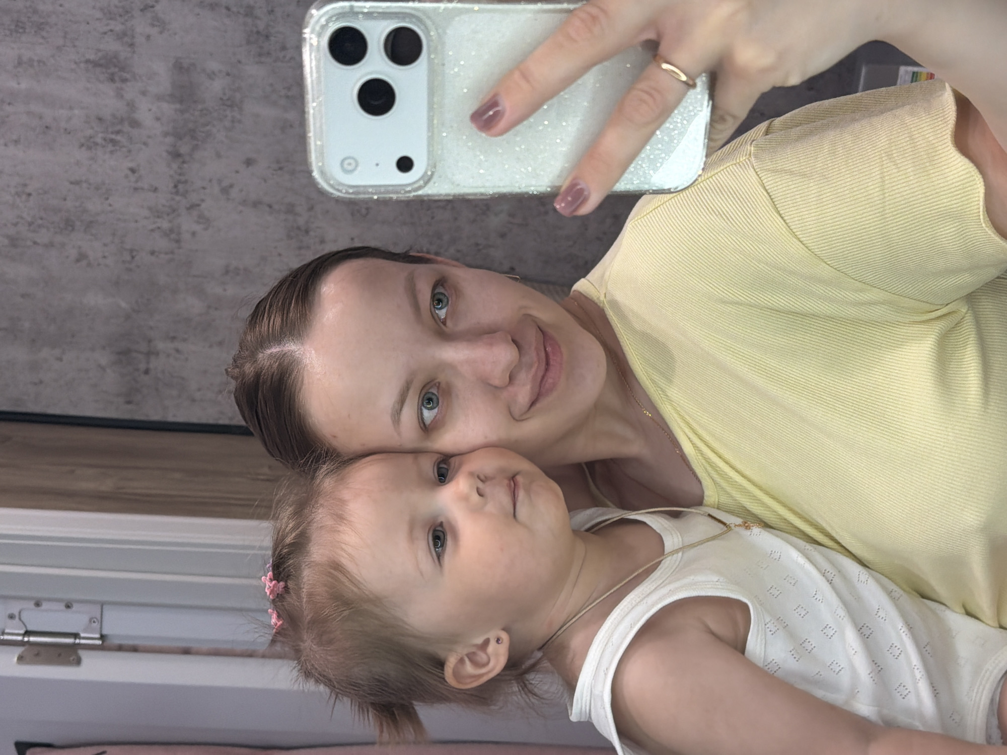 Mother and toddler take morning selfies in Reshetnikovo home