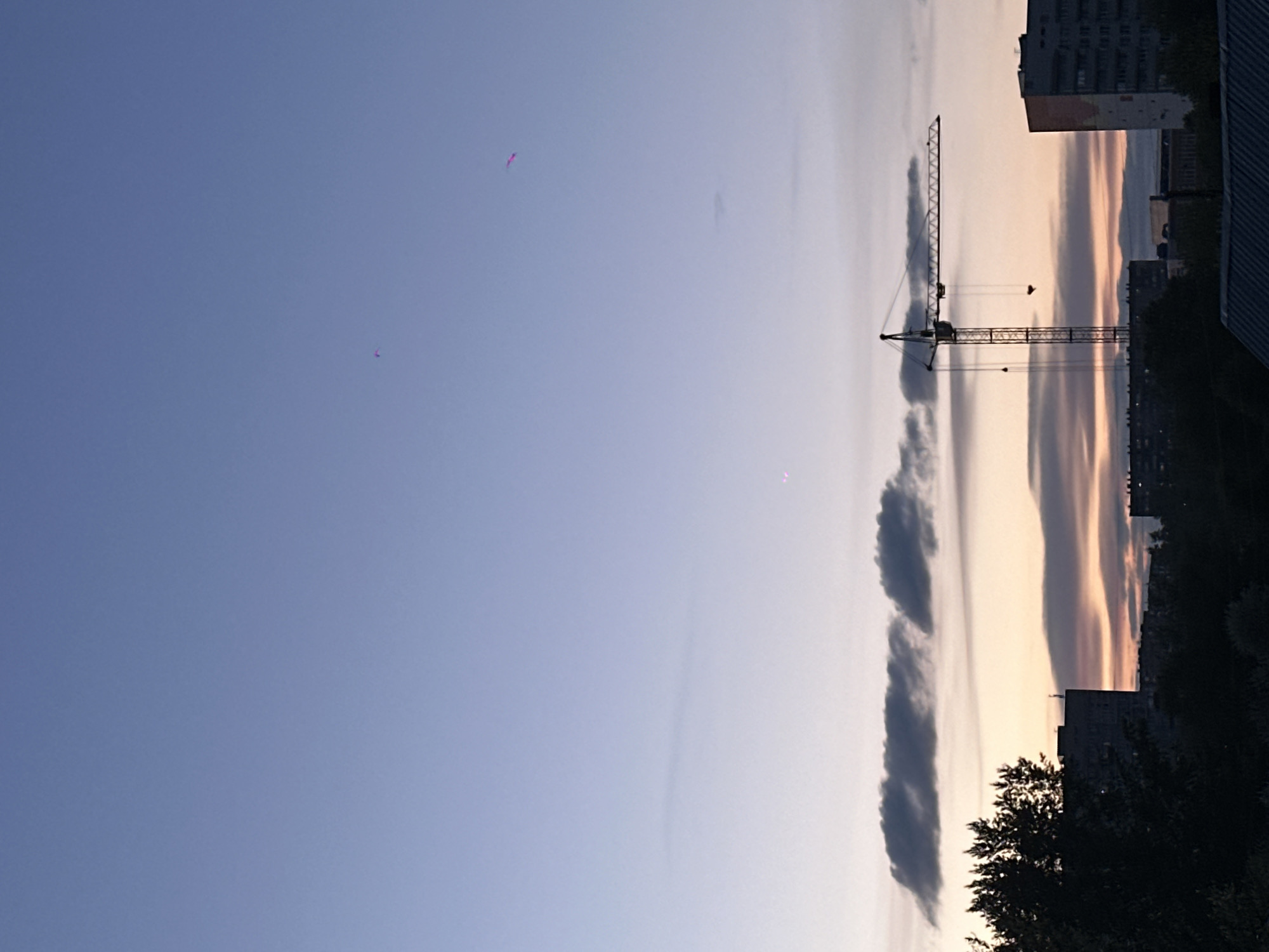 Construction cranes documented at dusk in Biysk, Russia