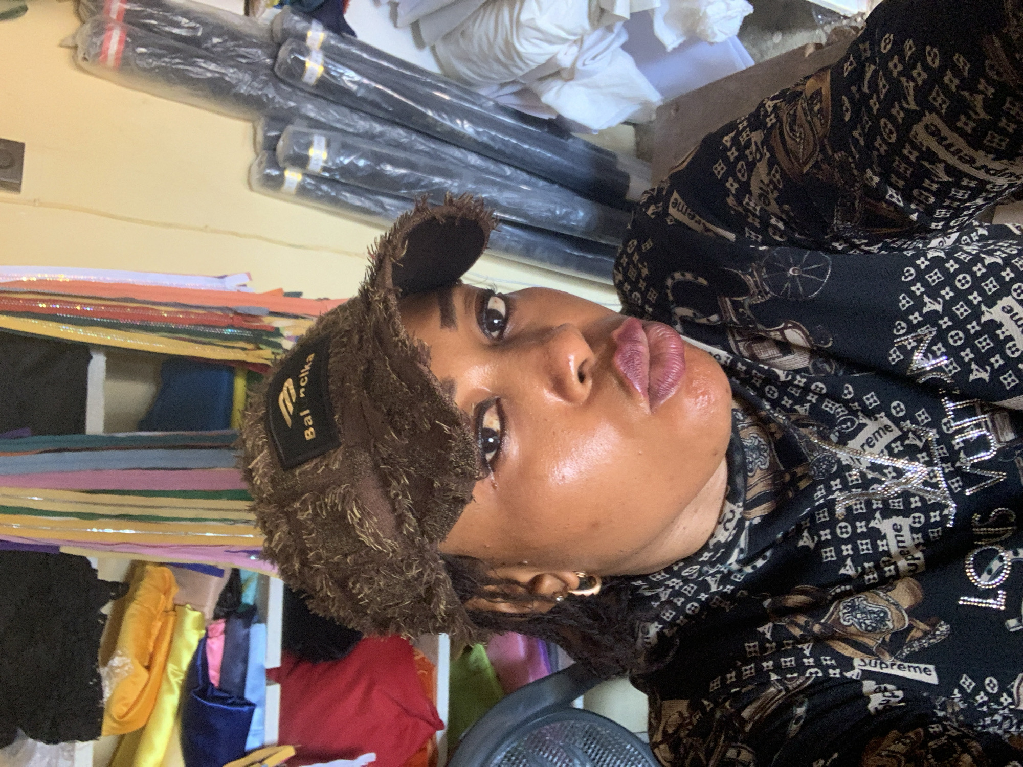 Selfie session showing streetwear-heavy look in Nigerian workshop space