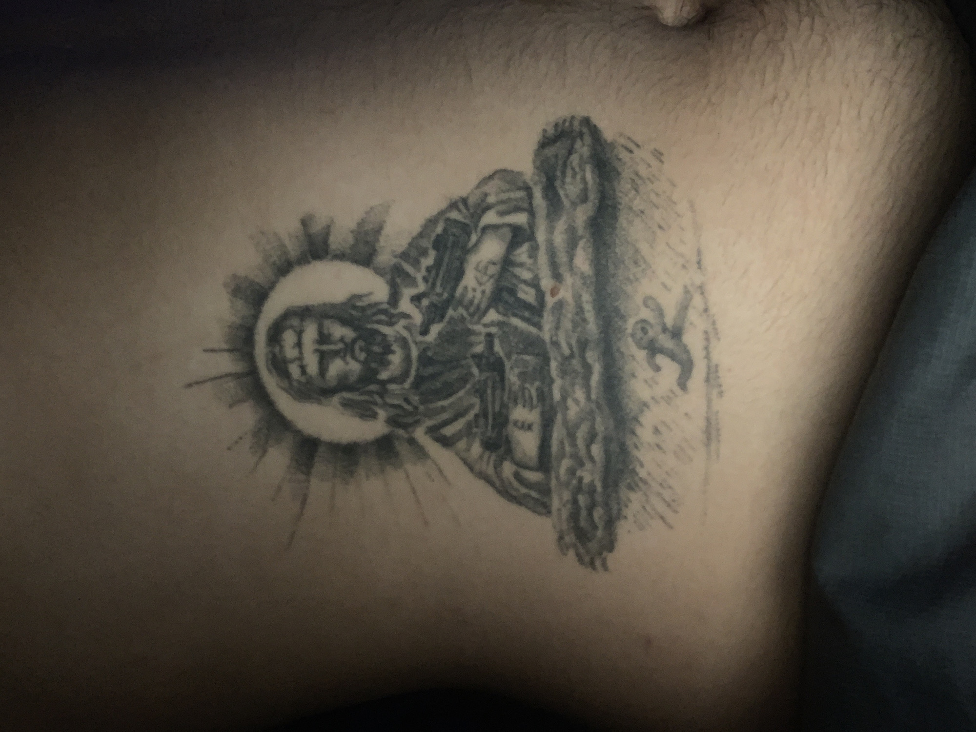 Religious tattoo featuring Christ figure documented in Buenos Aires