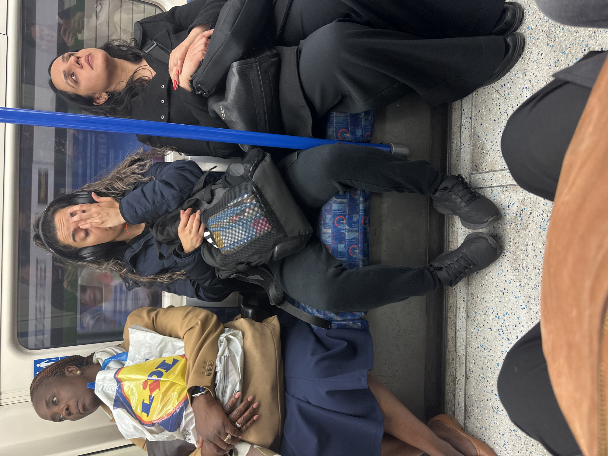 London scenes: Underground passengers and indoor art display observed