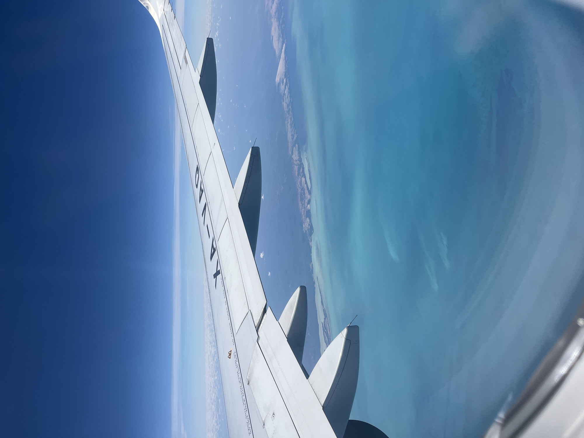 Aircraft XA-VAO flies over tropical waters near Ukum, Mexico