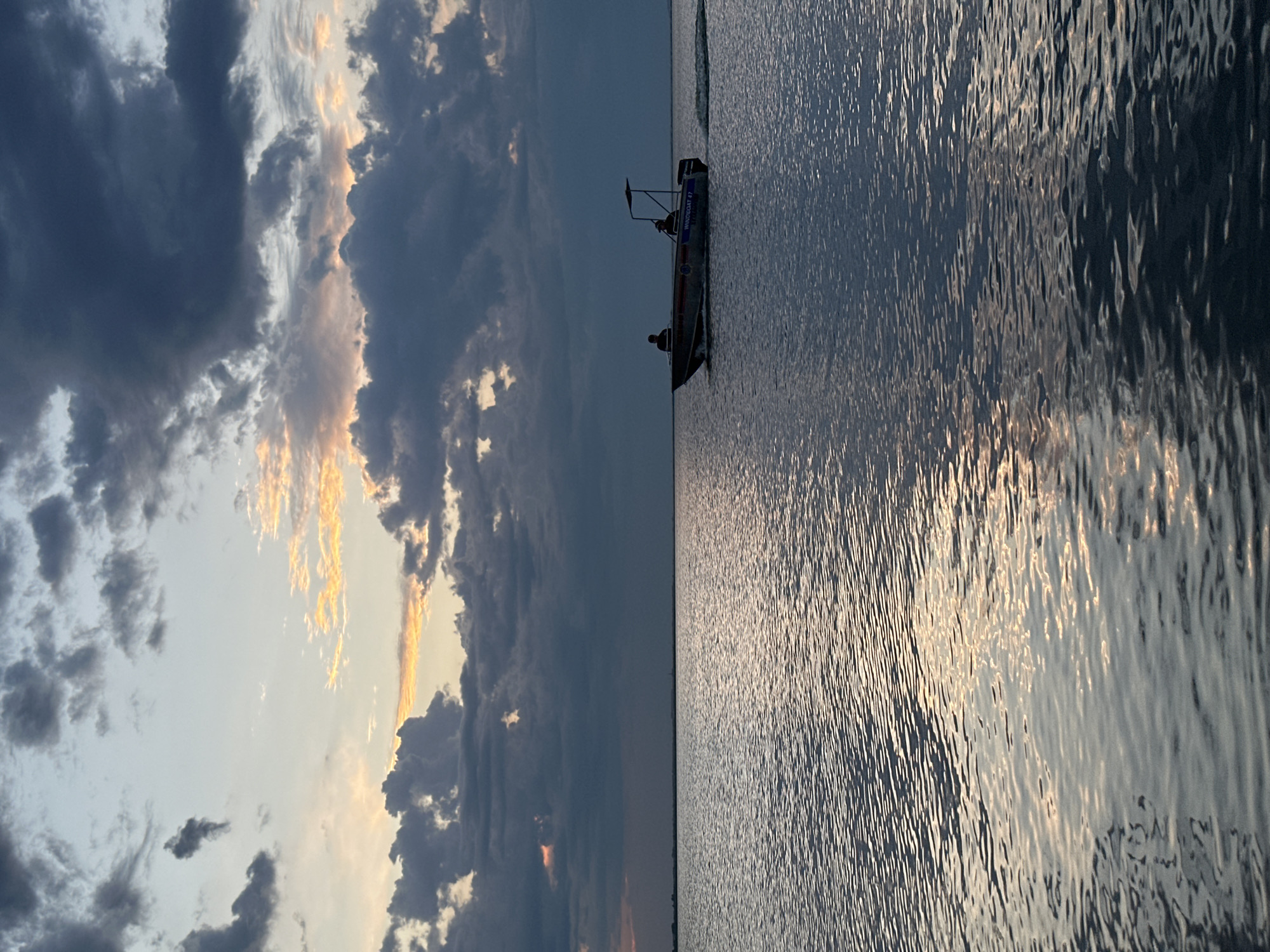 Dusk on a Kokshetau lake, stormy sky and a lone boat